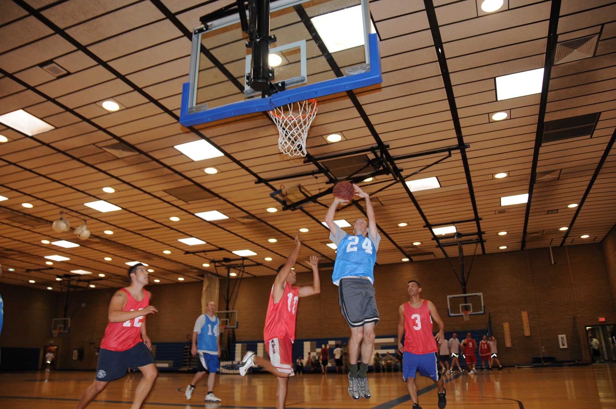 The 944th Communications Flight (in blue) takes on the 944th Logistics Readiness Squadron during a 3-on-3 basketball tournament at the base fitness center Sept. 16. The 944th Services Flight put on a tournament for wing members during the mandatory home station annual tour to encourage fitness and camaraderie. (U.S. Air Force photo/Tech. Sgt. Susan Stout) 
