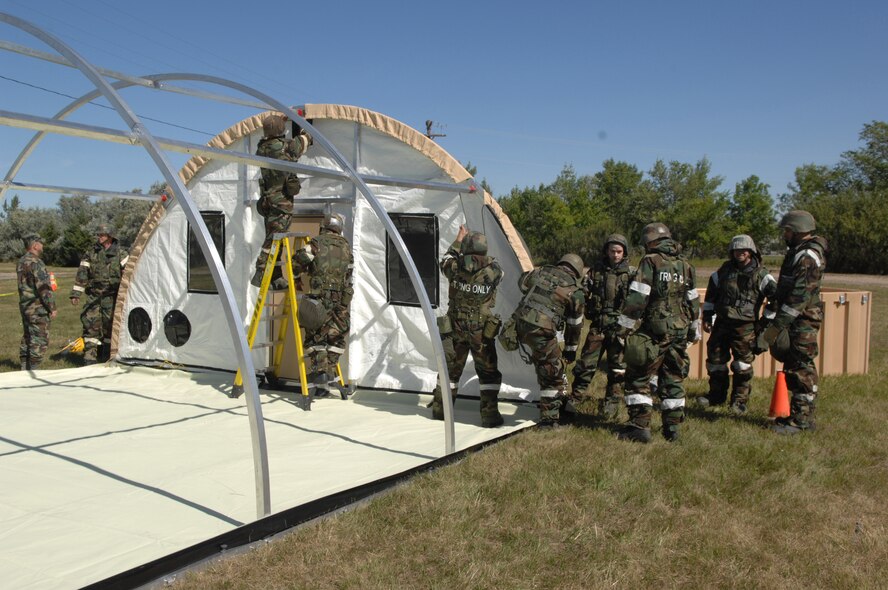 MINOT AIR FORCE BASE, N.D. -- Members of the 5th Civil Engineer Squadron put together an “Alaskan tent” during combat operations Sept. 9 as part of the Prairie Knight exercise Sept. 9 to 10. Prairie Knight is a phase II exercise designed to demonstrate unit capability to conduct sustained combat and mission support operations under simulated combat conditions. According to 5th CES personnel, shelter is critical during time of war. “Without a tent city you have no shelter; without shelter it’s game over,” said Staff Sgt. Chris Mercer. (U.S. Air Force Photo by Staff Sgt. Stacy Moless)