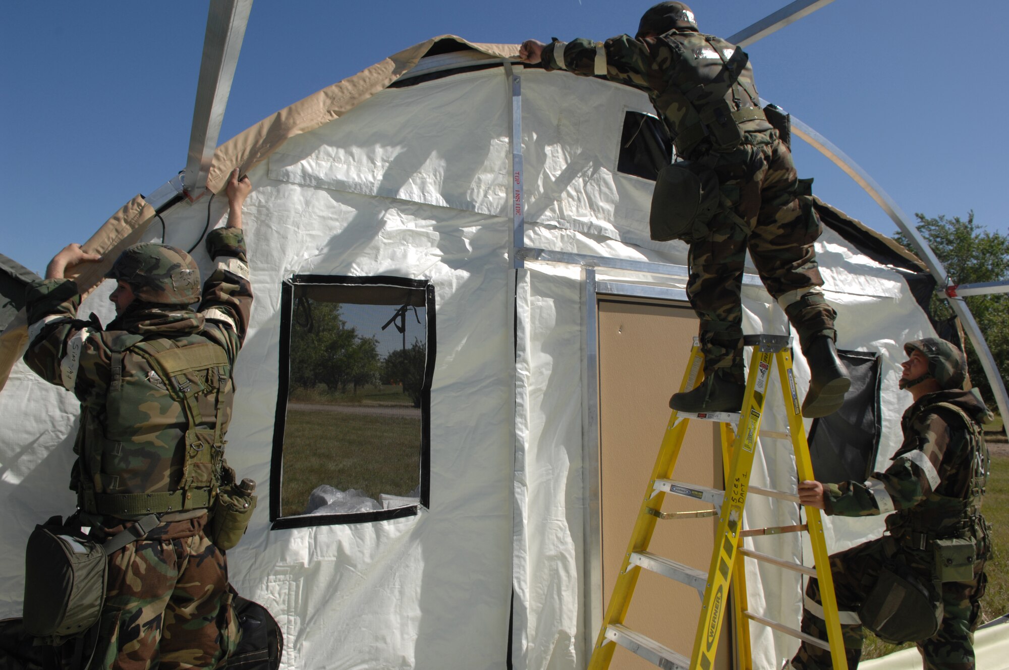 MINOT AIR FORCE BASE, N.D. -- Members of the 5th Civil Engineer Squadron put together an “Alaskan tent” during combat operations Sept. 9 as part of the Prairie Knight exercise Sept. 9 to 10. Prairie Knight is a phase II exercise designed to demonstrate unit capability to conduct sustained combat and mission support operations under simulated combat conditions. According to 5th CES personnel, shelter is critical during time of war. “Without a tent city you have no shelter; without shelter it’s game over,” said Staff Sgt. Chris Mercer. (U.S. Air Force Photo by Staff Sgt. Stacy Moless)