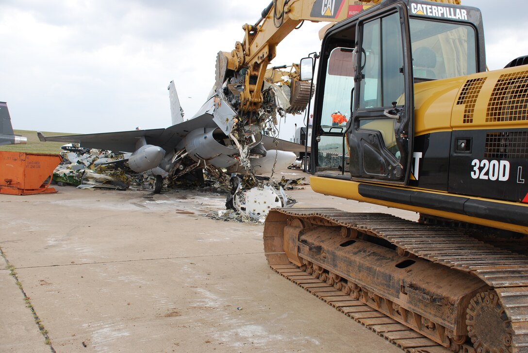 U.S. Navy contractors and the GeoMarine Corporation begin their disposal process of two F-16 trainers Sept. 16. These are two of eight aircraft scheduled for disposal. Sheppard is a test site for an aircraft disposal method that could possibly be used Air Force-wide. (U.S. Air Force photo/ Airman 1st Class Valerie Hosea)