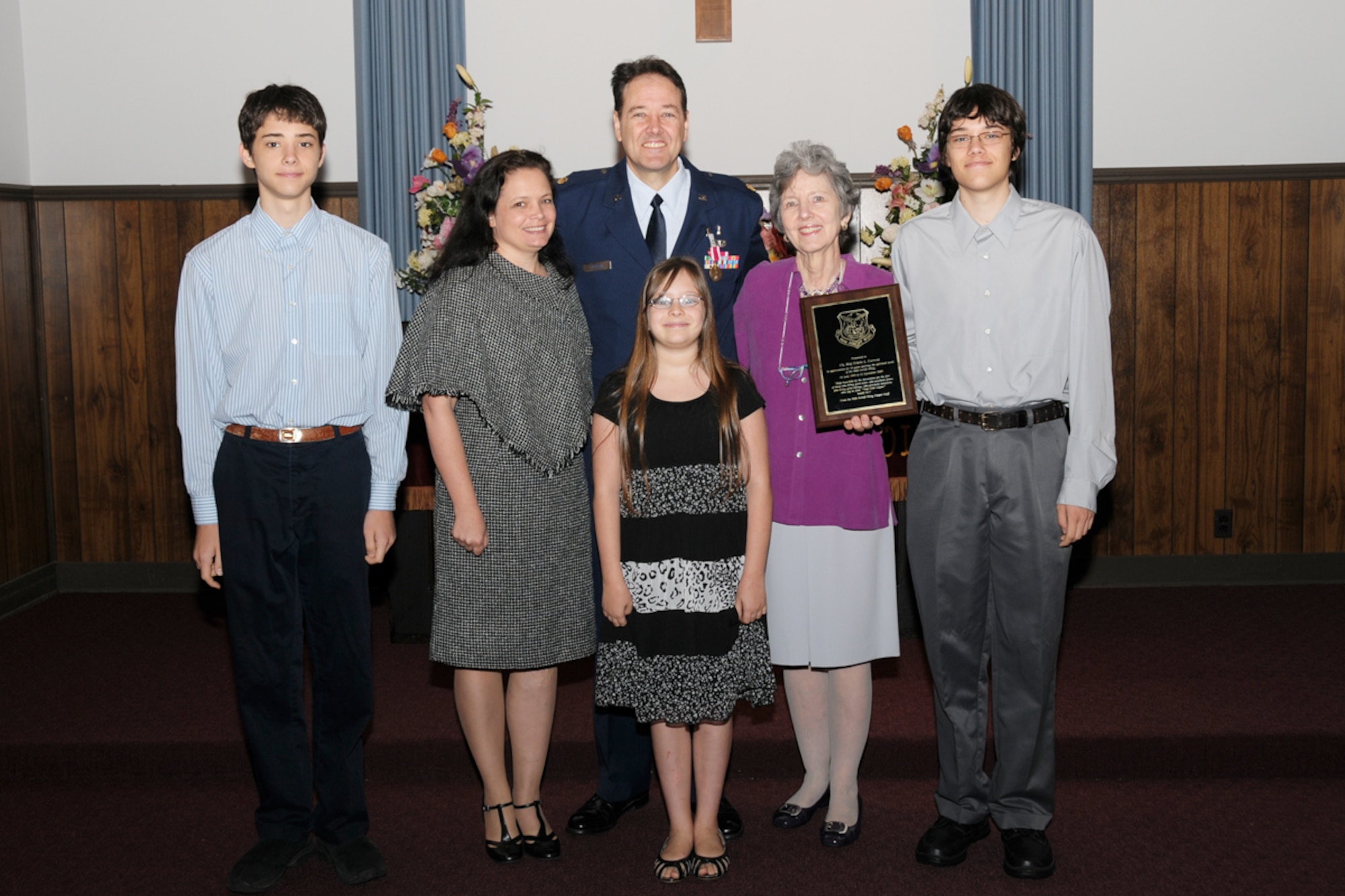 Chaplain (Maj.) Erwin L. Carrow celebrates with his family, Sheldon Arel, son, Sharon Elizabeth, wife,  Elise Gabri, daughter, Rose Marie Sanders, mother, Caleb Elias, son and Lucian Joshua (not shown) at his farewell service and awards ceremony Sept. 13.(U.S. Air Force photo/Tech. Sgt. Nicholas Ontiveros)