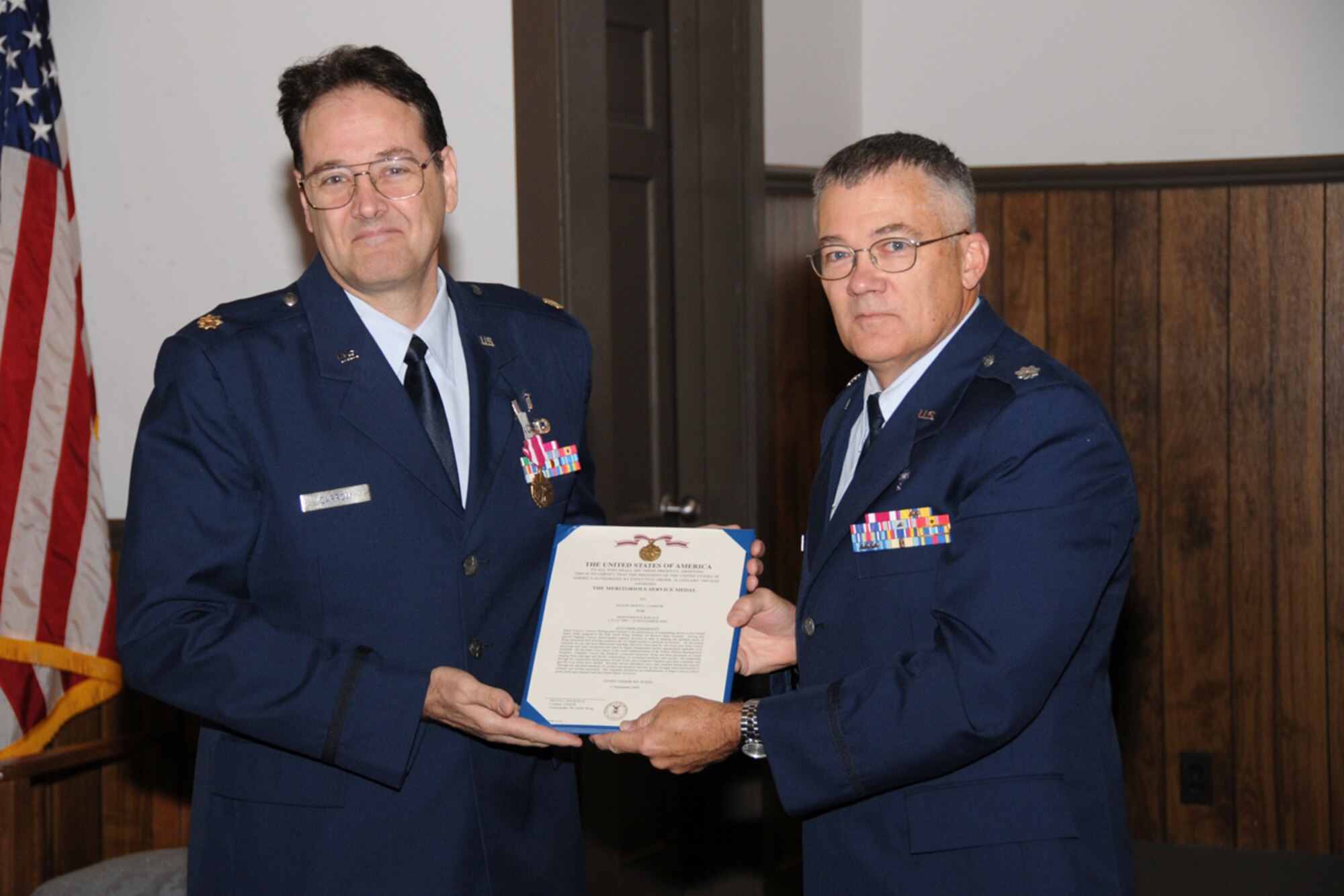 Chaplain (Maj.) Erwin L. Carrow  is presented a Meritorious Service Medal by Chaplain (Lt. Col.) William B. Ferrell of the 94th Airlift Wing during his farewell service and awards ceremony Sept. 13. (U.S. Air Force photo/Tech. Sgt. Nicholas Ontiveros)
