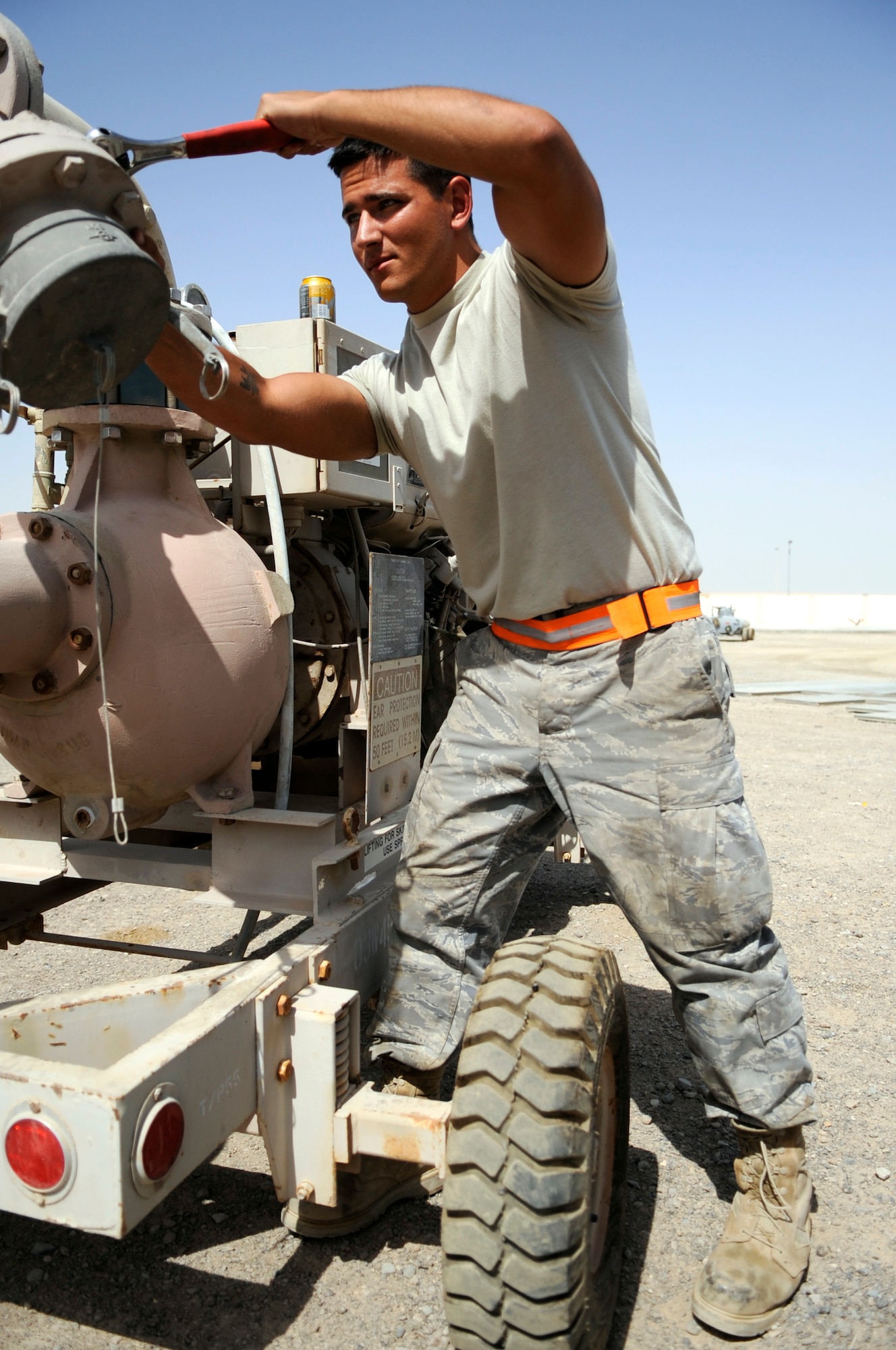 SOUTHWEST ASIA- Airman 1st Class Jeffrey Poland, 380th Expeditionary Logistics Readiness Squadron, works on an R-22 fuel pumping unit here Sept. 16, 2009. As a mobile refueling maintainer, Airman Poland works on a variety of equipment and vehicles used to fuel operations here at the 380th Air Expeditionary Wing. (U.S. Air Force photo/Senior Airman Stephen Linch)