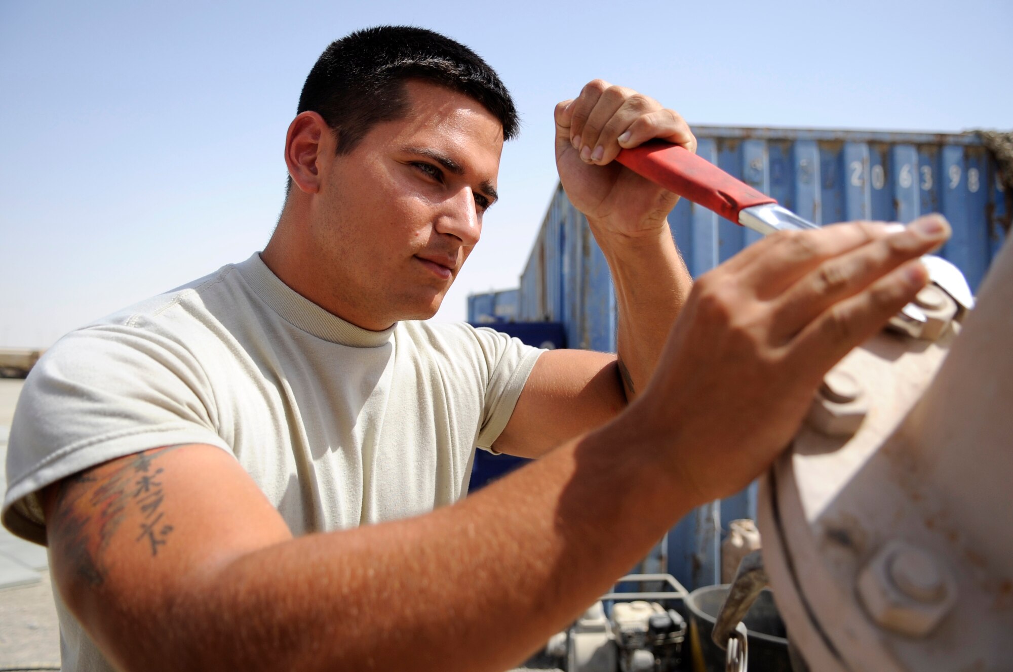 SOUTHWEST ASIA- Airman 1st Class Jeffrey Poland, 380th Expeditionary Logistics Readiness Squadron, works on an R-22 fuel pumping unit here Sept. 16, 2009. Airman Poland is deployed from Fairchild Air Force Base, Wash., and grew up Oscoda, Mich. (U.S. Air Force photo/Senior Airman Stephen Linch)