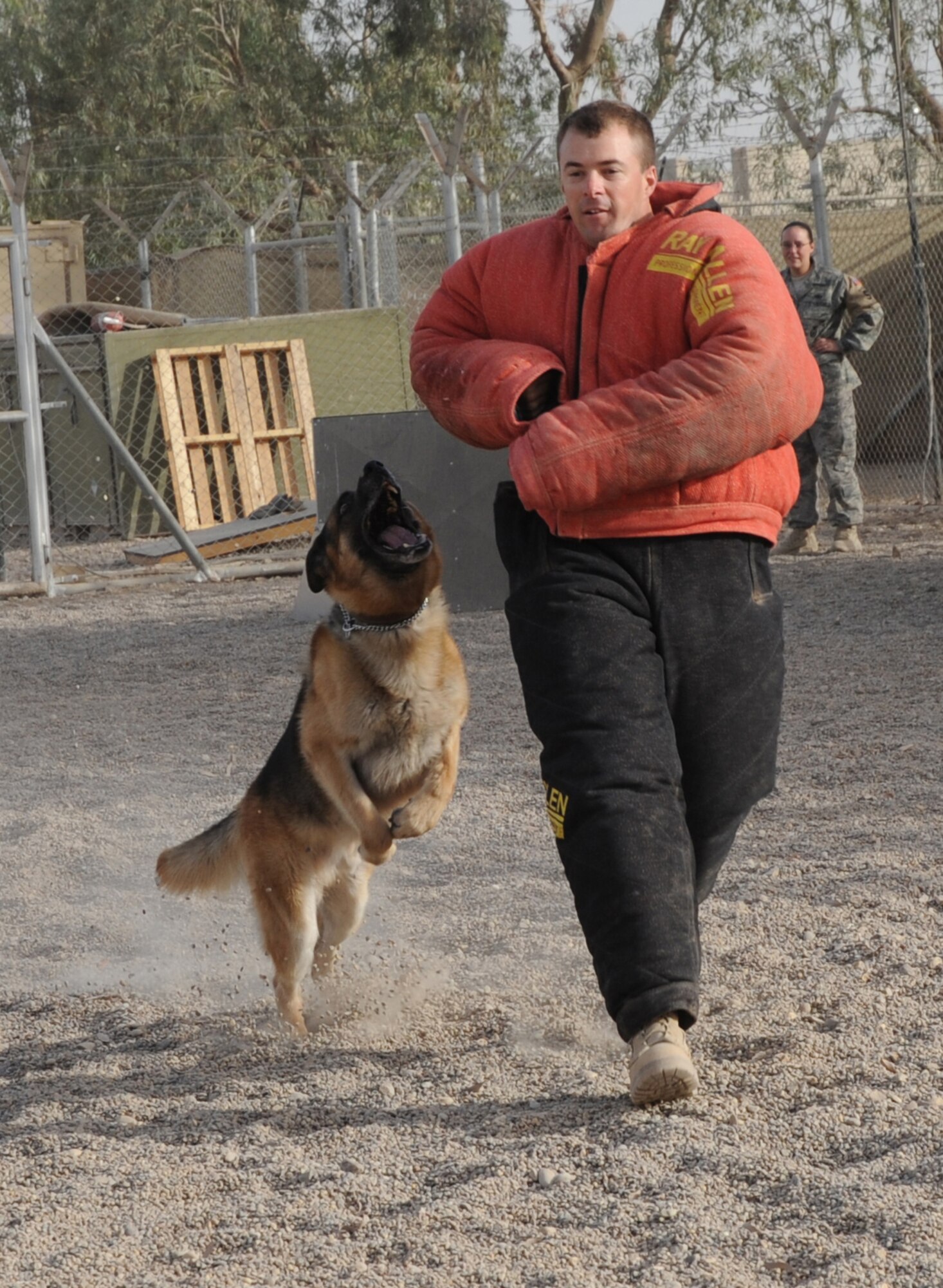 SATHER AIR BASE, Iraq -- Chaplain (Capt.) Chad Montgomery, 447th Air Expeditionary Group, wears a bite suit as he runs from Kibo, 447th Expeditionary Security Forces Squadron K-9, during a training session here Sept. 14, 2009. These sessions help military working dogs train on biting other parts of the body as opposed to only biting arms. Chaplain Montgomery has made it his goal to get involved by helping Airmen with their daily missions and training during his deployment. Chaplain Montgomery is deployed from Lackland Air Force Base, Texas, and is a native of Newtown Square, Pa. (U.S. Air Force photo/Tech. Sgt. Johnny L. Saldivar)