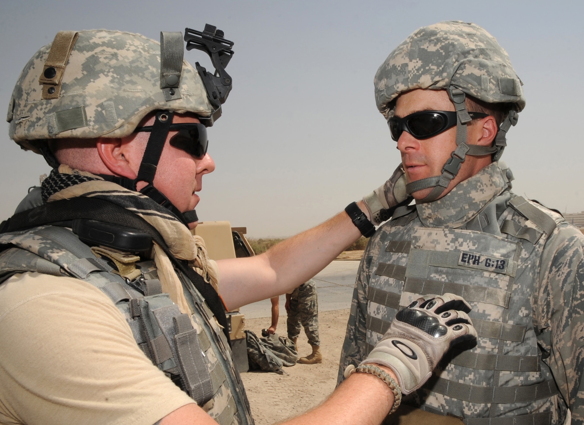 SATHER AIR BASE, Iraq -- Air Force Staff Sgt. Chris Martin (left), 447th Expeditionary Security Forces Squadron installation patrolman, performs a buddy-check on Air Force Chaplain (Capt.) Chad Montgomery, 447th Air Expeditionary Group, to ensure he is properly wearing his protective body armor  prior to a security patrol here Sept. 10, 2009. Chaplain Montgomery has made it his goal to get involved by helping Airmen with their daily missions and training during his deployment. Sergeant Martin is deployed from Fairchild Air Force Base, Wash., and is a native of Spokane, Wash., and Chaplain Montgomery is deployed from Lackland AFB, Texas, and is a native of Newtown Square, Pa. (U.S. Air Force photo/Tech. Sgt. Johnny L. Saldivar)