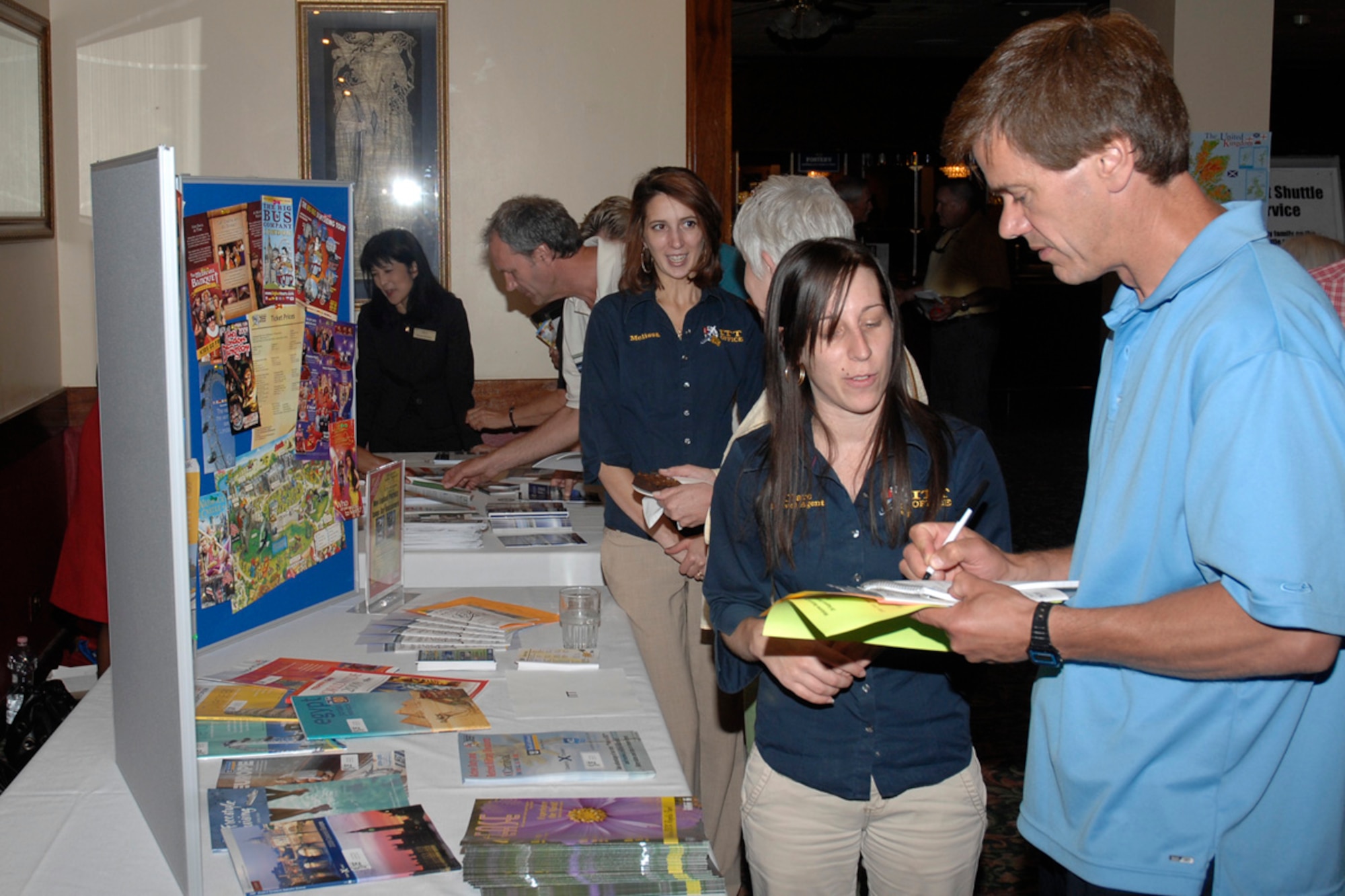 Greg Mako, a new Department of Defense Dependents Schools U.K. employee and high school science and math teacher, takes advantage of an event offered through Information, Tickets and Travel during the Welcome Back and Overseas Orientation for DoDDS employees held at the Eagles’ Landing Officers’ Club on Aug. 26, 2009, at RAF Lakenheath, England.  The venue gave DoDDS employees an opportunity to meet with base leadership and discover what services the base provides. (U.S. Air Force photo/Senior Master Sgt. Thomas Wood) 