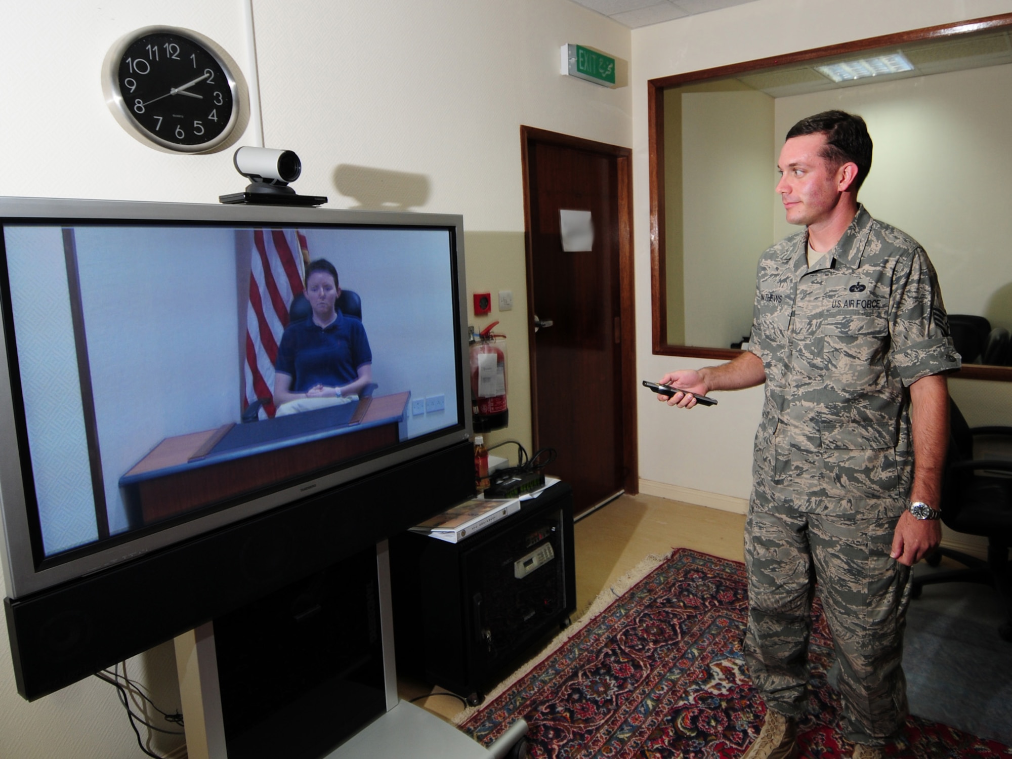 Staff Sgt. Robert Mathews, 379th Air Expeditionary Wing NCOIC military justice, sets up a video teleconference for witness testimony during a home-station courts martial, here, Sept. 16. Sergeant Mathews is deployed from Kadena Air Base, Japan in support of Operations Iraqi and Enduring Freedom. (U.S. Air Force Photo/Tech. Sgt. Jason W. Edwards)