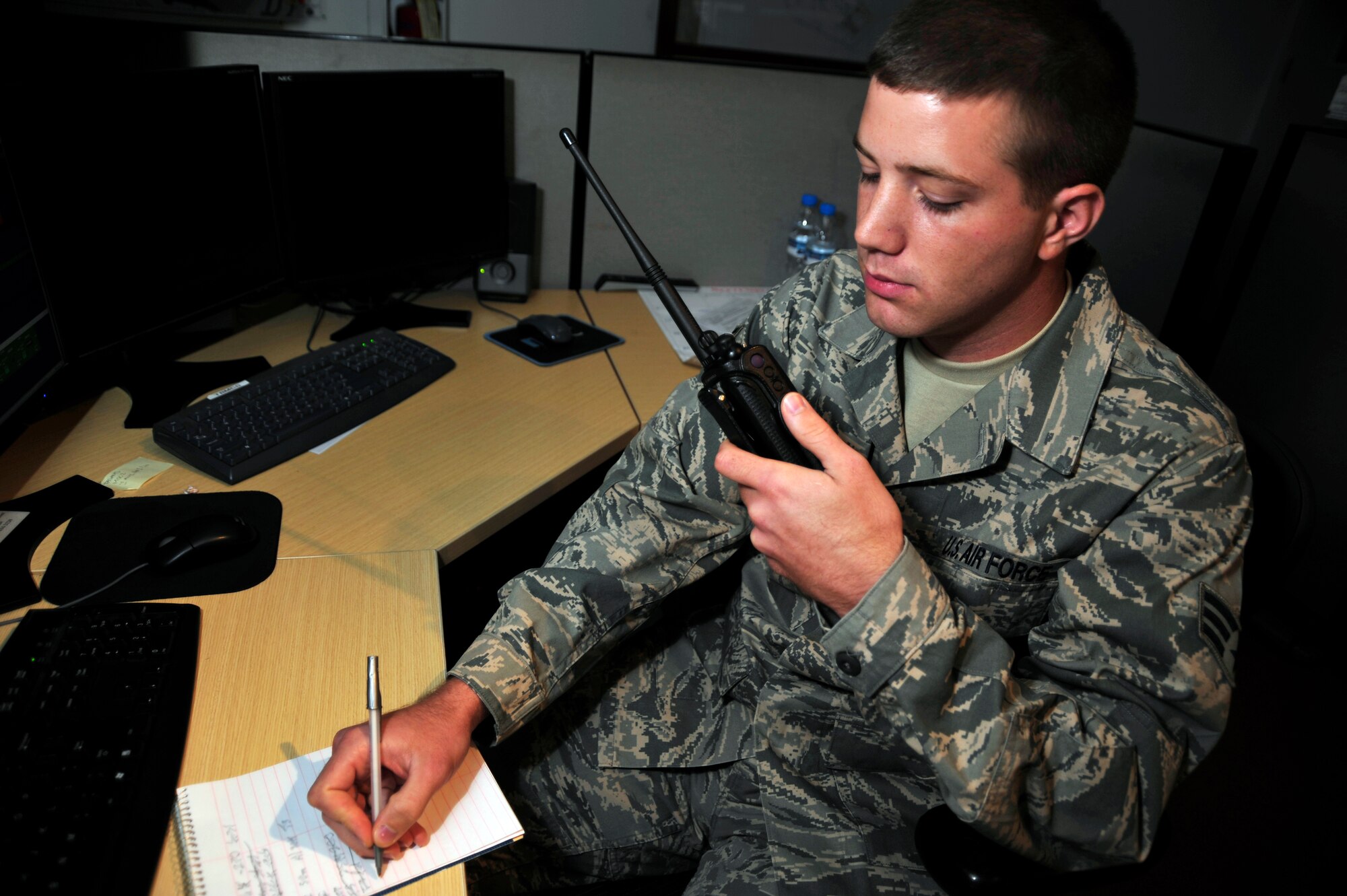 SOUTHWEST ASIA -Senior Airman Timothy Serjeant, 380th Expeditionary Maintenance Squadron, takes notes while receiving aircraft maintenance information via land mobile radio Sept. 16, 2009. Airman Serjeant is deployed from McGuire Air Force Base, N.J., and hails from Tri-Cities, Wash. (U.S. Air Force photo/Tech. Sgt. Charles Larkin Sr)