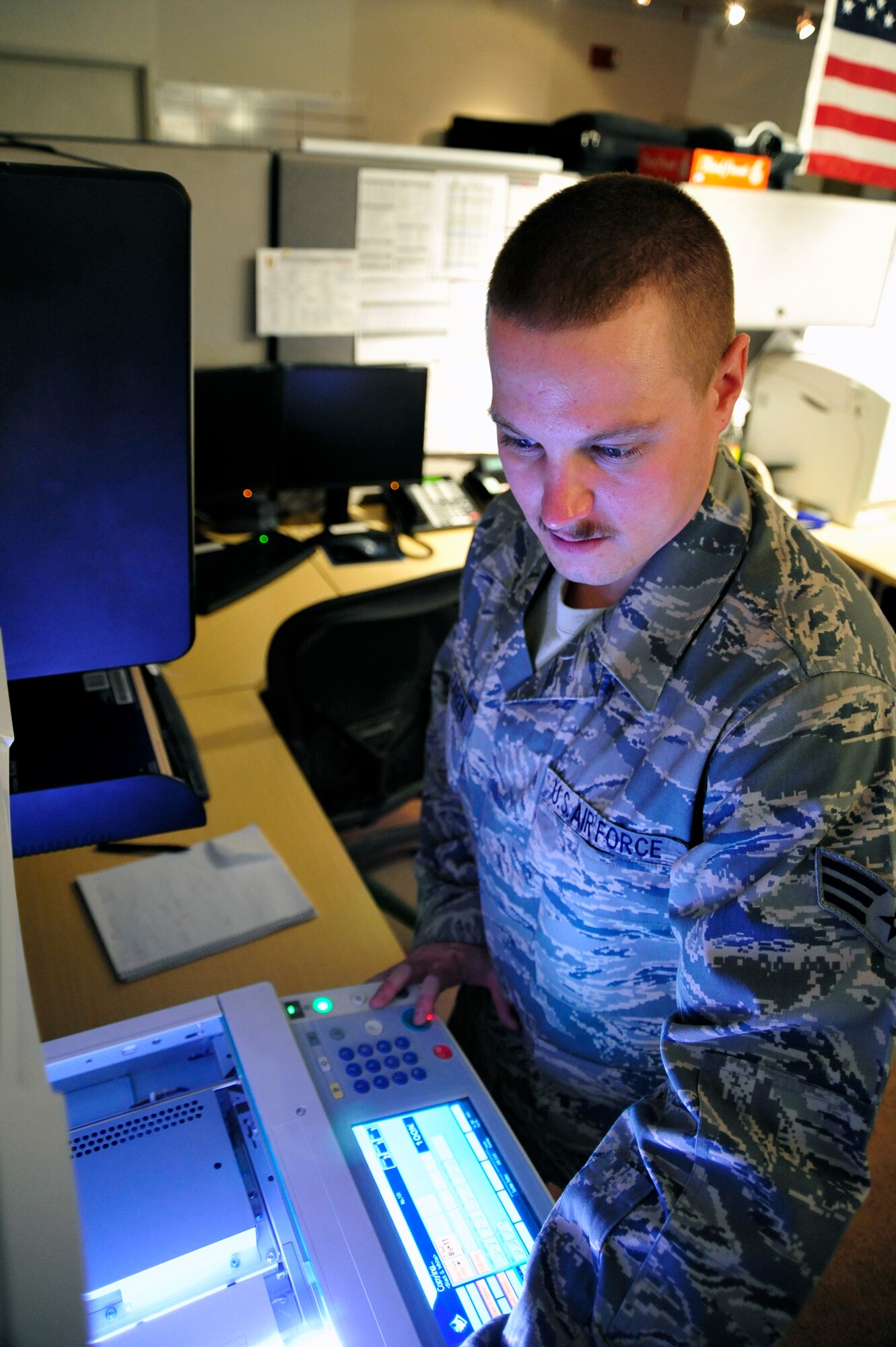 SOUTHWEST ASIA -Senior Airman Dustin Mc Clearen, 380th Expeditionary Maintenance Squadron, makes copies of the daily schedule Sept. 16, 2009. Airman Mc Clearen is deployed from Beale Air Force Base, Calif., and hails from Sacramento, Calif. (U.S. Air Force photo/Tech. Sgt. Charles Larkin Sr)