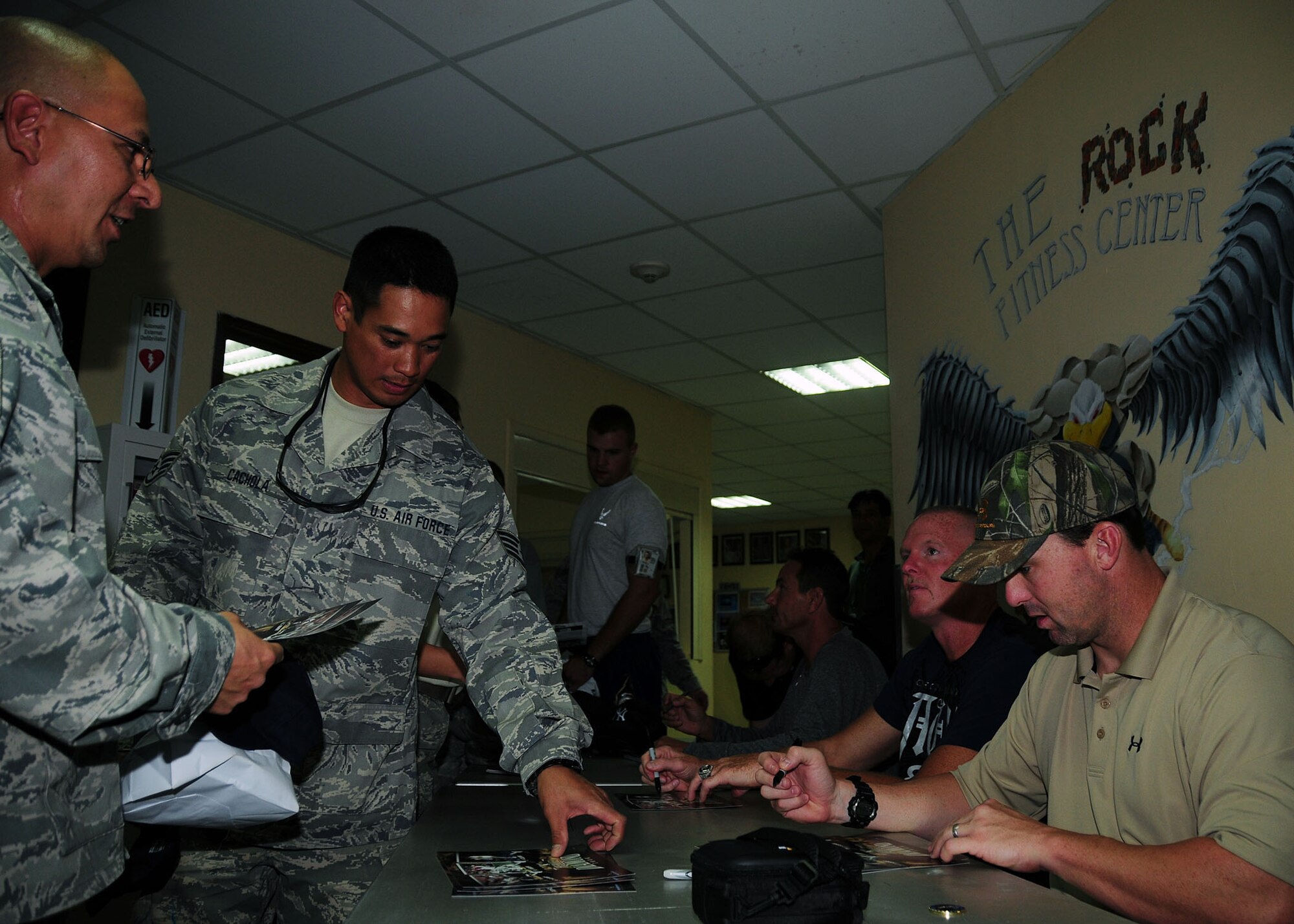 SOUTHWEST ASIA -- 386th Air Expeditionary Wing members receive autographs from former major league baseball players (from left to right) Andy Ashby, San Diego Padres pitcher, Jeff Nelson, New York Yankees pitcher and Trot Nixon, Boston Red Sox outfielder, held during a Heroes of the Diamond tour at an undisclosed location in Southwest Asia Sept. 16, 2009.  (U.S. Air Force photo/Tech. Sgt. Tony Tolley)