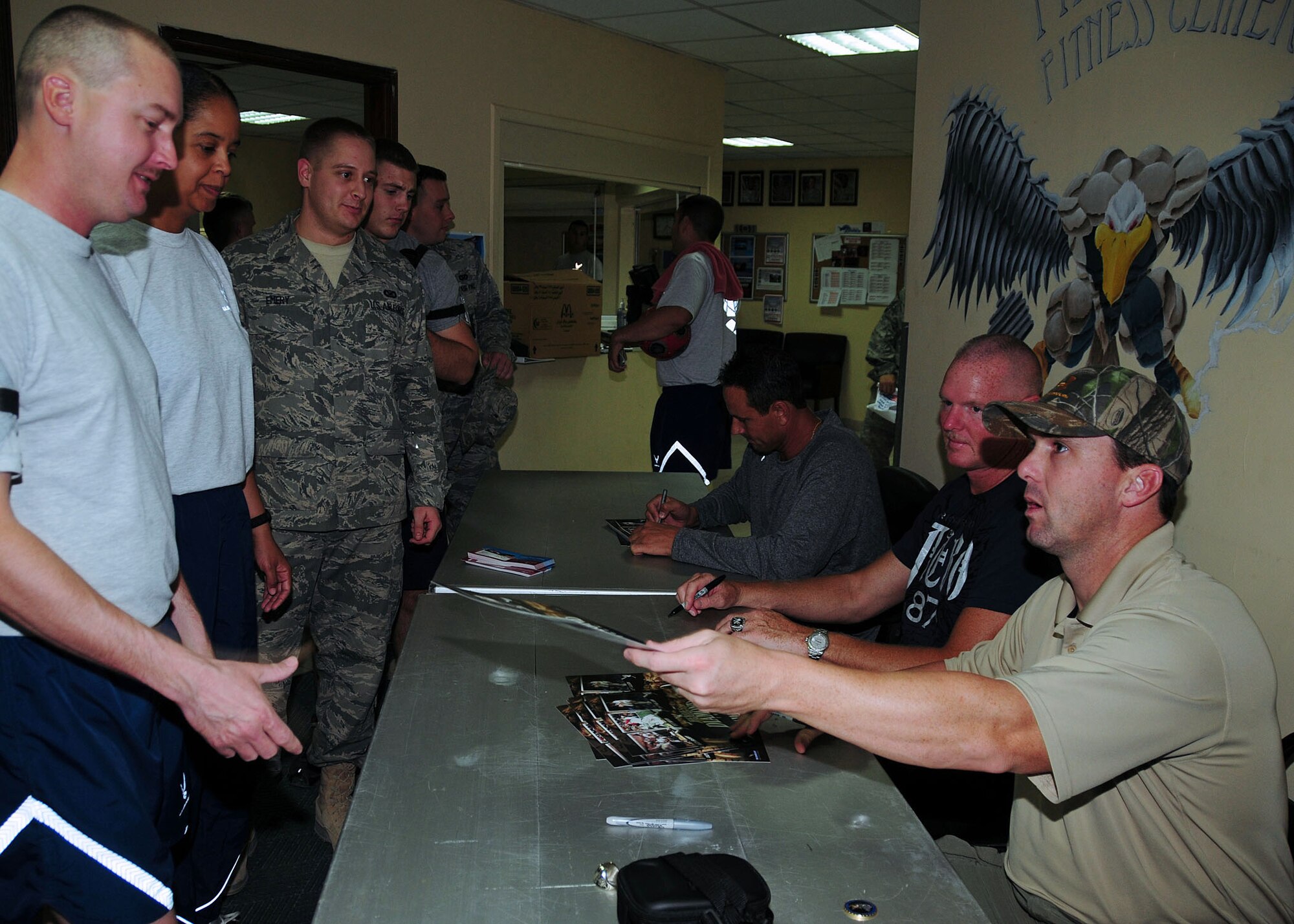 SOUTHWEST ASIA -- 386th Air Expeditionary Wing members receive autographs from former major league baseball players (from left to right) Andy Ashby, San Diego Padres pitcher, Jeff Nelson, New York Yankees pitcher and Trot Nixon, Boston Red Sox outfielder, held during a Heroes of the Diamond tour at an undisclosed location in Southwest Asia Sept. 16, 2009.  (U.S. Air Force photo/Tech. Sgt. Tony Tolley)