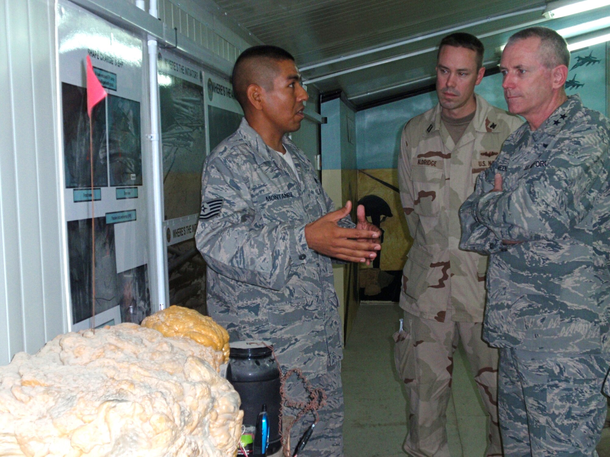 SOUTHWEST ASIA -- Maj. Gen. Brian Meenan, CENTCOM Deployment & Distribution Operations Center director, receives a briefing on the threat of improvised explosive devices from Tech. Sgt. Guadalupe Montanez, convoy commander, Sept. 8 during a visit to the 586th Expeditionary Logistics Readiness Squadron?s motor pool. (U.S. Air Force photo/1st Lt. Rachel Egley)