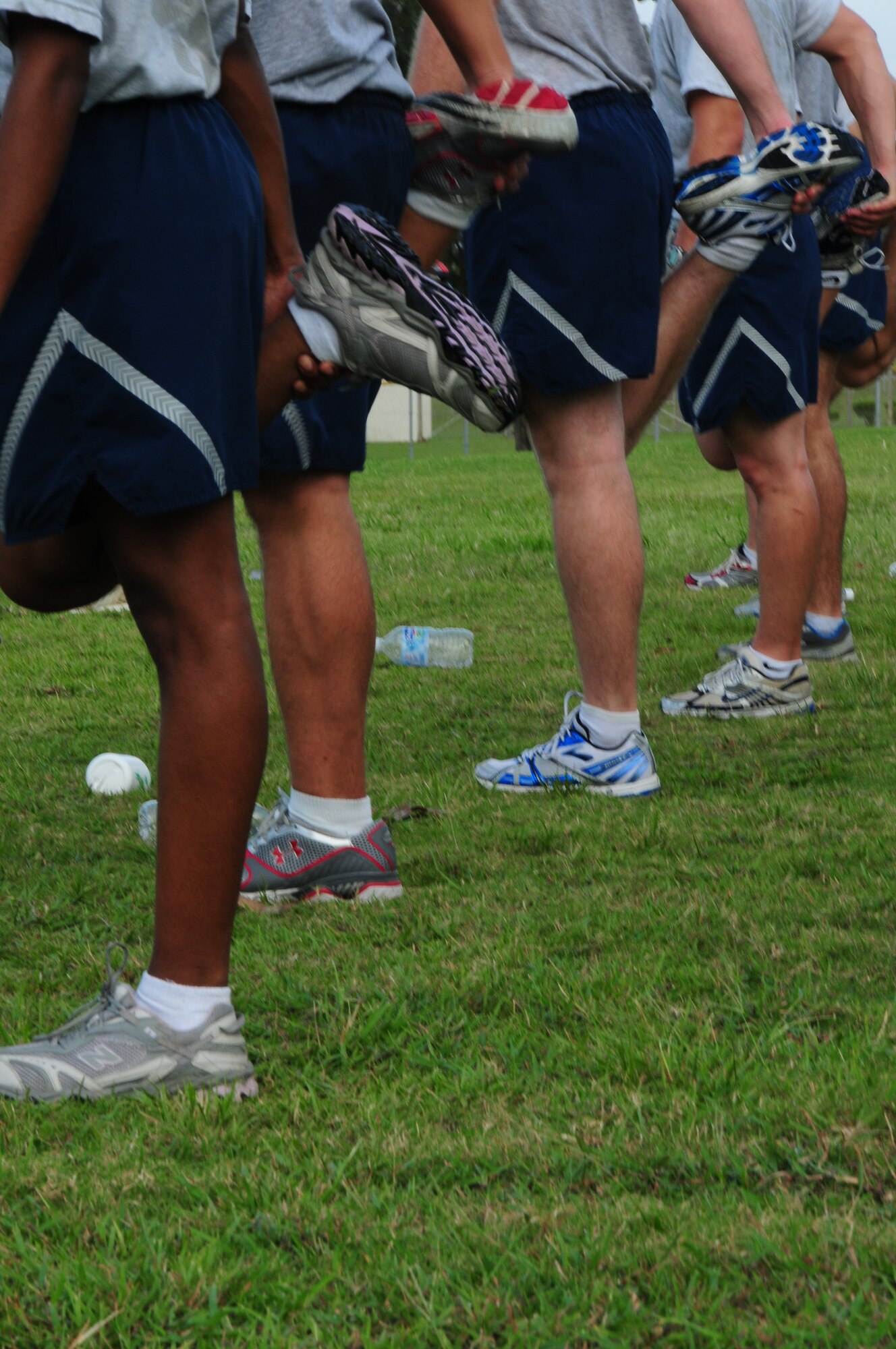 Members of the 18th Logistics Readiness Squadron vehicle maintenance flight stretch their quadriceps as part of their routine cool down after a 5K run. Sergeant Truan says that they are constantly looking for ways to improve their PT program. One of their projects for the near future is to add circuit training to their routine.
  
(U.S. Air Force photo/Staff Sgt. Lakisha A. Croley)
