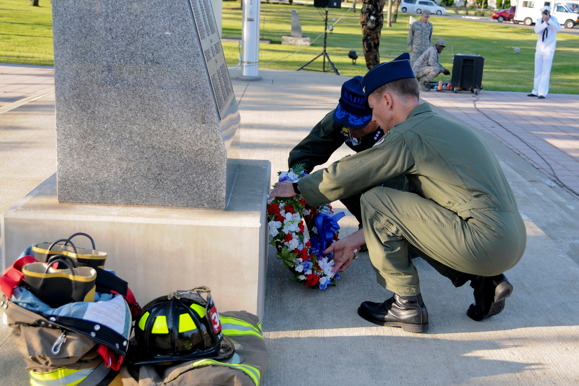 MISAWA AIR BASE, Japan -- Col. David Stilwell, 35th Fighter Wing commander, and Lt. Gen. Kiyoshi Yada, Northern Air Defense Force commander, place a commemorative wreath during a 9/11 retreat ceremony at Risner Circle here. Although the 9/11 terrorist attacks occurred on American homeland, citizens of many different countries and nationalities lost their lives on that tragic day. (U.S. Air Force photo/Senior Airman Jamal D. Sutter)