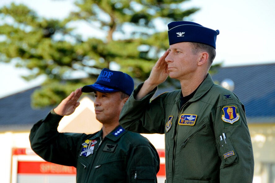 MISAWA AIR BASE, Japan -- Col. David Stilwell, 35th Fighter Wing commander, and Lt. Gen. Kiyoshi Yada, Northern Air Defense Force commander, salute during the playing of Taps, Sept. 11 At Risner Circle here. Although the 9/11 terrorist attacks occurred on American homeland, citizens of many different countries and nationalities, to include Japan, lost their lives on that tragic day. (U.S. Air Force photo/Senior Airman Jamal D. Sutter)