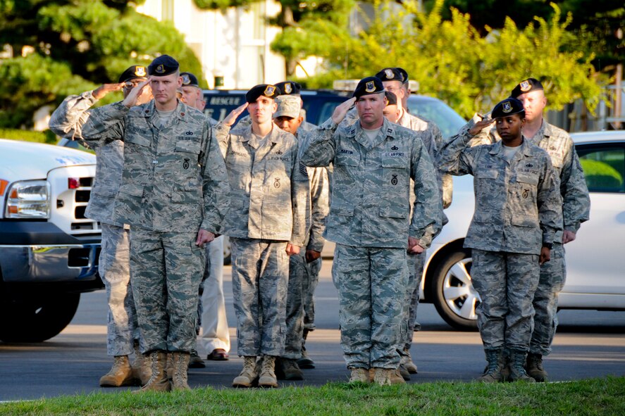 MISAWA AIR BASE, Japan -- Members of the 35th Security Forces Squadron salute during the playing of Taps, Sept. 11 at Risner Circle here. The squadron, along with other Misawa Air Base first responders, commemorated those who risked and lost their lives in response to the 9/11 terrorist attacks. (U.S. Air Force photo/Senior Airman Jamal D. Sutter)