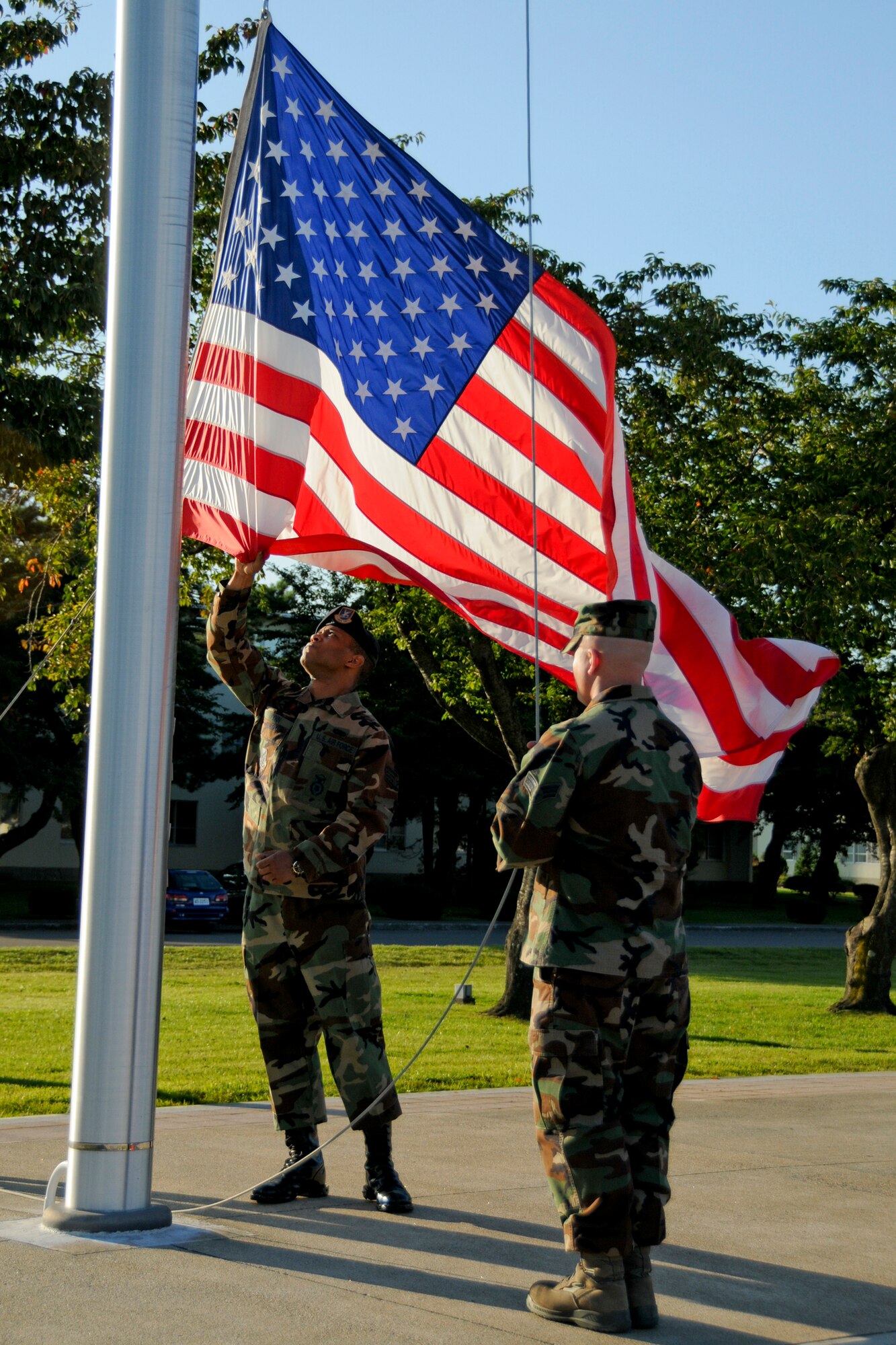 MISAWA AIR BASE, Japan -- Members of the Misawa Air Base Honor Guard retire the colors during a 9/11 retreat ceremony at Risner Circle here. The ceremony served as a time to honor the victims and first responders who risked and lost their lives in the 9/11 terrorist attacks. (U.S. Air Force photo/Senior Airman Jamal D. Sutter)