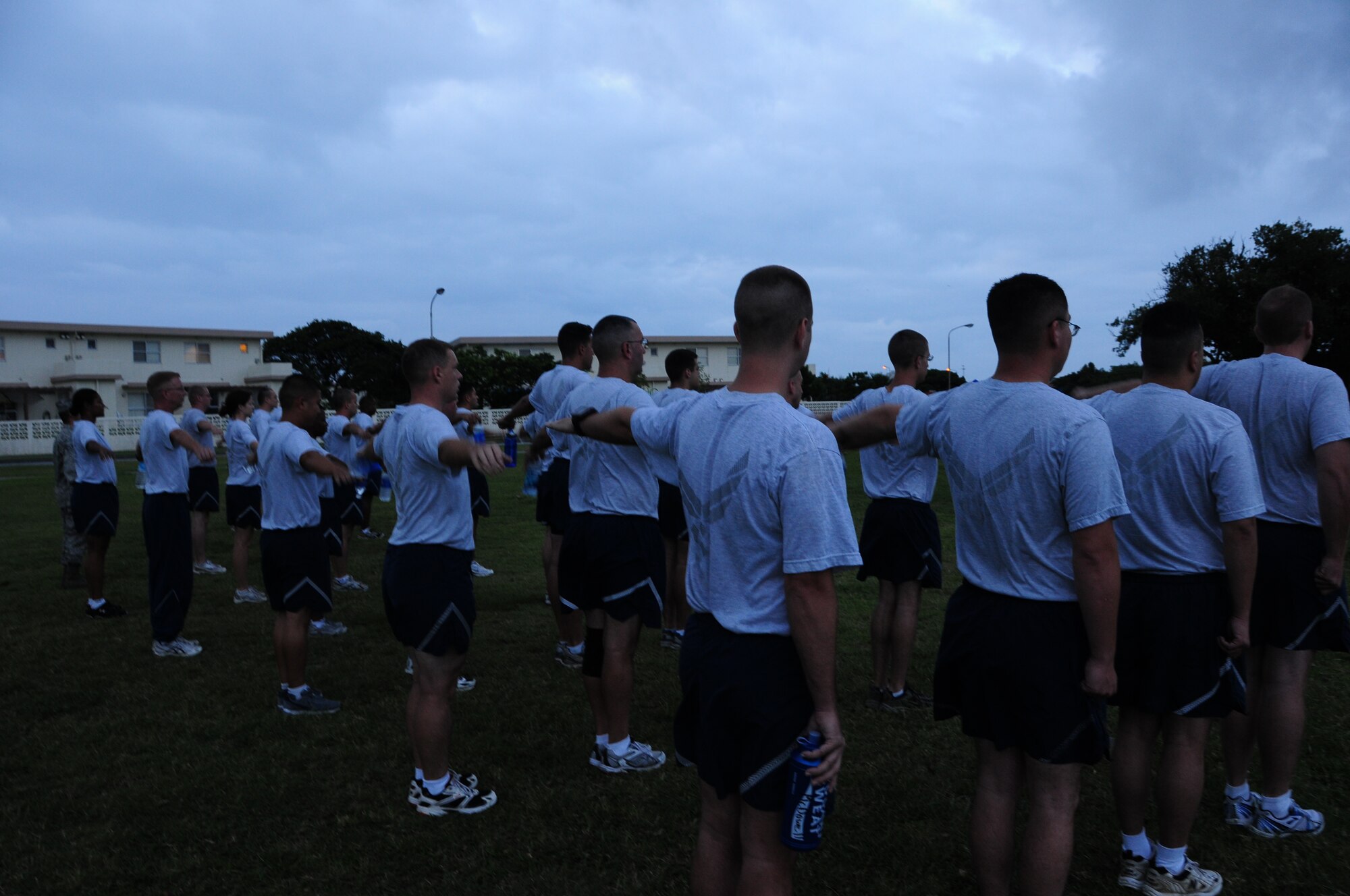Members of the 18th Logistics Readiness Squadron vehicle maintenance flight size up basic training-style before stretching at Kadena Air Base, Japan. Their current PT program, established in 2006, continues to evolve. Master Sgt. Treon Truan, the flight superintendent, says their goal is to be "Fit to fight, not fit to pass." 

(U.S. Air Force photo/Staff Sgt. Lakisha A. Croley)
