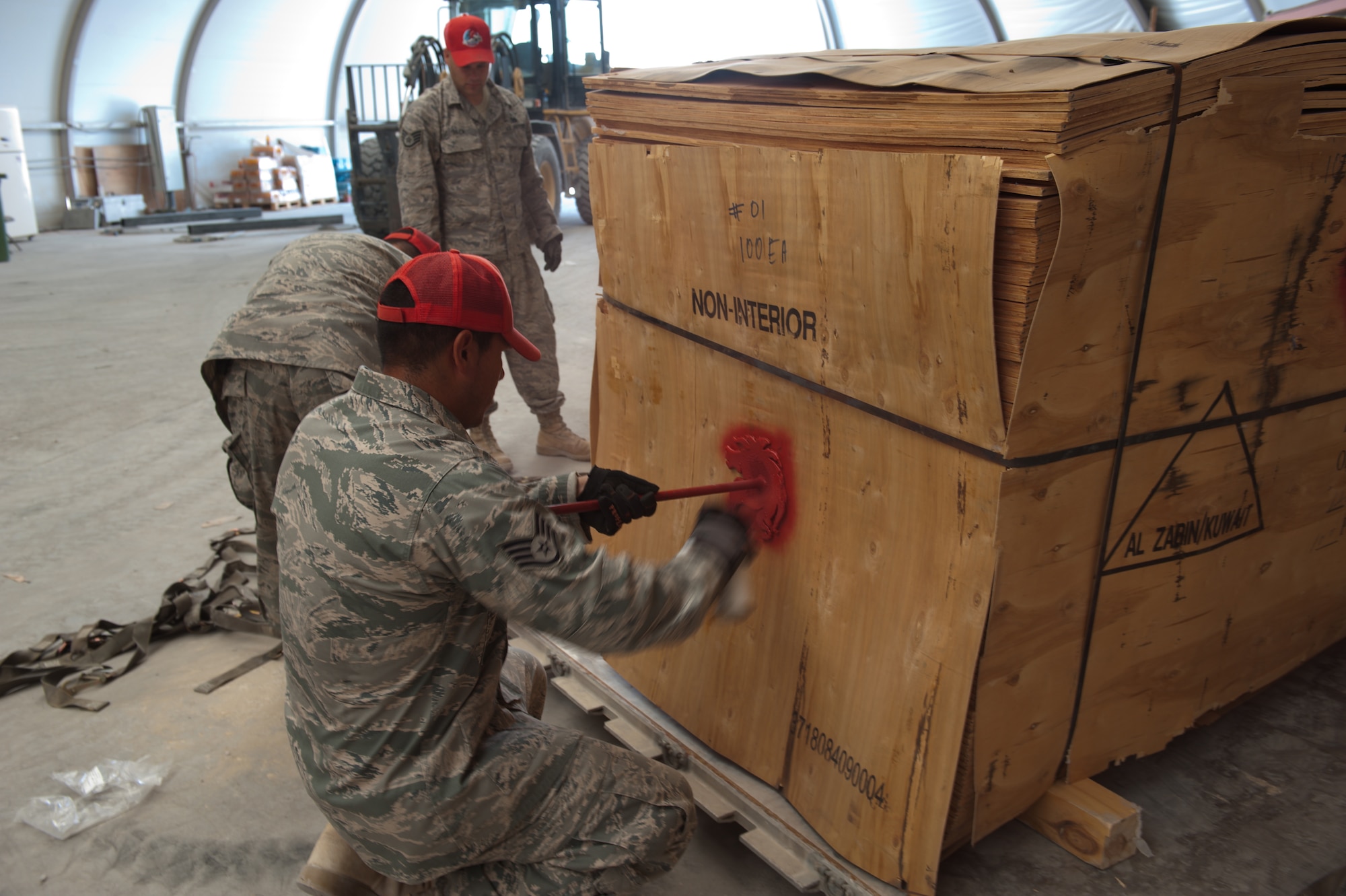 U.S. Air Force Staff Sgt. Dennis Urruchi, 1st Expeditionary RED HORSE Group electrical craftsman, marks a pallet with the ?Red Horse? for palletizing and shipping to Bagram Airfield, Sept. 15, in Southwest Asia. Sergeant Urruchi, along with fellow servicemembers of the logistics and pallet build-up team, support all RED HORSE operations downrange by obtaining and shipping required equipment for mission success. Sergeant Urruchi is deployed from Peterson Air Force Base, Colo., in support of Operations Iraqi and Enduring Freedom. (U.S. Air Force Photo/Staff Sgt. Robert Barney/RELEASED)