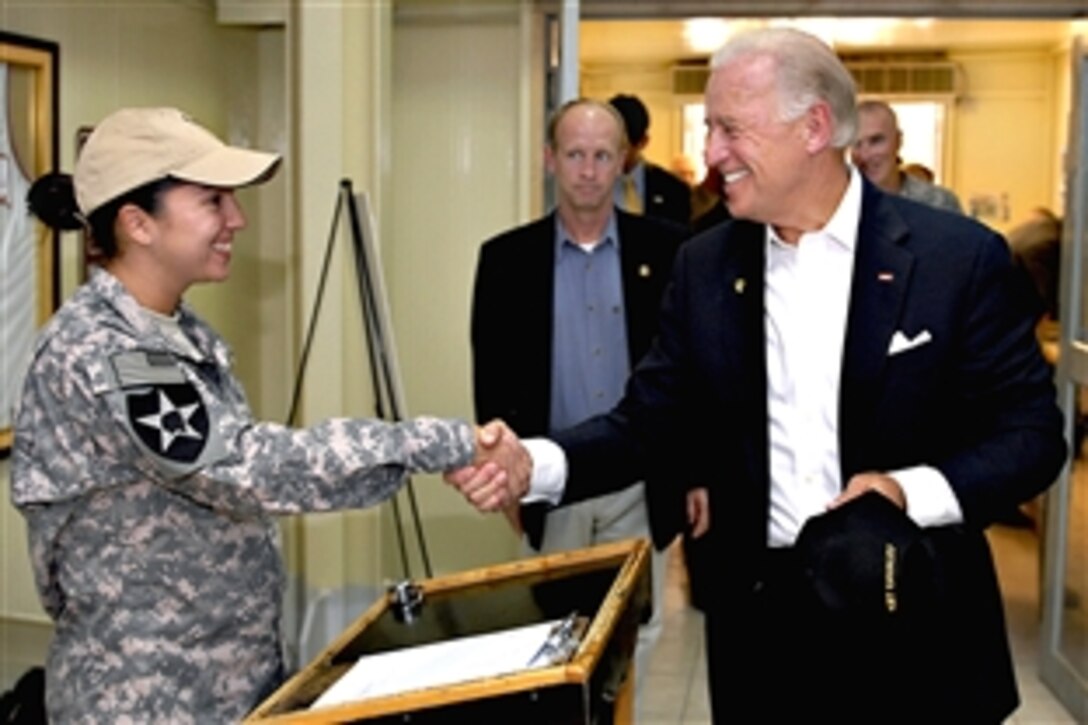 U.S. Army Spc. Tonya Nichols greets Vice President Joe Biden as he makes a surprise visit to military personnel at the Pegasus Dining Facility on Camp Liberty in Baghdad, Sept. 17, 2009. Nichols is assigned to Headquarters Support Company, Division Special Troops Battalion, Multinational Division Baghdad.