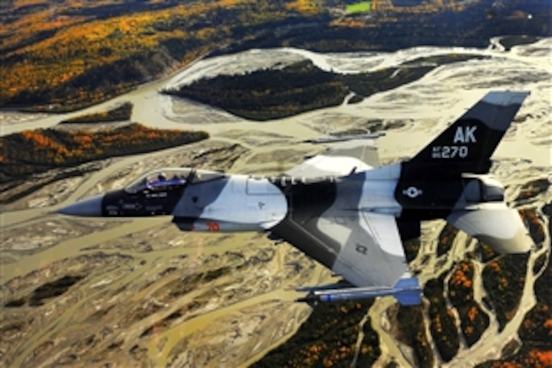 A U.S. Air Force F-16 Aggressor aircraft flies over the Joint Pacific Alaskan Range Complex near Eielson Air Force Base, Alaska, Sept. 14, 2009. The F-16 is assigned to the 18th Aggressor Squadron, which is responsible for training and preparing joint and allied aircrews for combat missions.