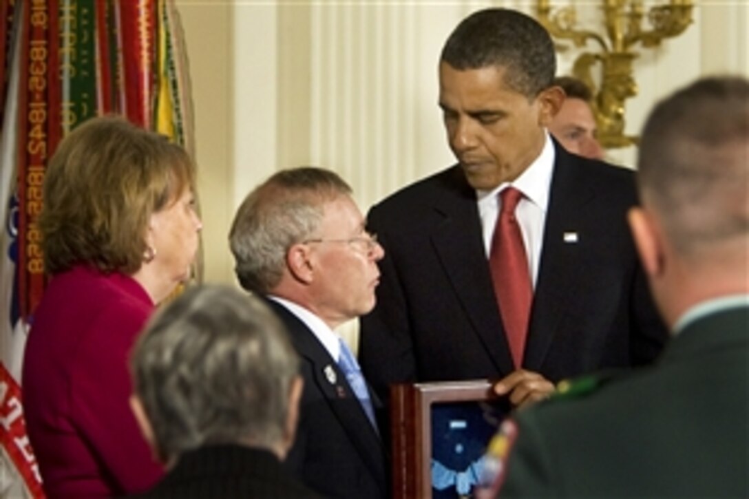 President Barack Obama posthumously awards Army Sgt. 1st. Class Jared C. Monti from Raynham, Mass., the Medal of Honor to his parents, Paul and Janet Monti, in the East Room of the White House in Washington, D.C., Sept. 17, 2009.