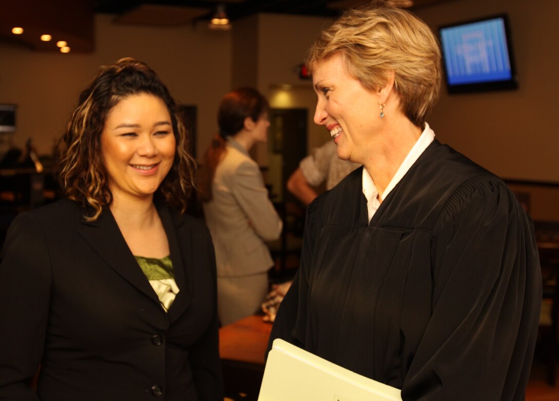 U.S. District Judge Barbara L. Major talks with her Clerk of the Court before presiding over Camp Pendleton’s naturalization ceremony where 99 active-duty service members became U.S. citizens, Sept. 17.