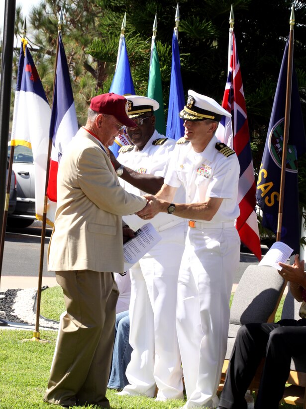 Guest speaker Ralph Kling, vice commander, American Ex-Prisoners of War, shakes hands with Navy Captain Paul D. Pearigan, commanding officer, Naval Hospital, Camp Pendleton, after speaking at the 19th annual POW/MIA Memorial Service at the Naval Hospital, Sept. 18.