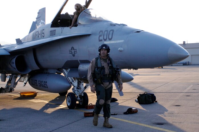 Maj. Jerry Estell, Marine Fighter Attack Squadron 115 aircraft maintenance officer, walks around his F/A-18 fighter jet, inspecting it moments after arriving here Sept. 17. VMFA-115 arrived here out of Marine Corps Air Station Beaufort, S.C. for a six-month tour as part of the Unit Deployment Program.
