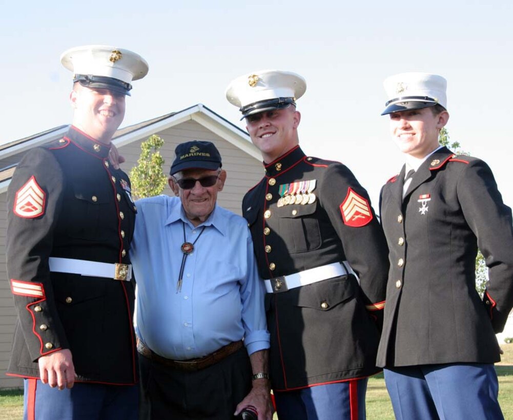 Marines took time out of the celebration to pose with Mr. Melvin Moore, a 90-year-old Marine Corps and World War II veteran. (Left to Rigt) Staff Sgt. William Genochio, a recruiter with RSS North Indianapolis, Melvin Moore, Sgt. Brian Frances, a recruiter with RSS North Indianapolis , and Pvt. Brianna Ayers, a young Marine recently returning from recruit training.