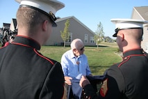 Marines took time out of the celebration to pose with Mr. Melvin Moore, a 90-year-old Marine Corps and World War II veteran. (Left to Rigt) Staff Sgt. William Genochio,a recruiter with RSS North Indianapolis, Melvin Moore, Sgt. Brian Frances, a recruiter with RSS North Indianapolis , and Pvt. Brianna Ayers, a young Marine recently returning from recruit training.