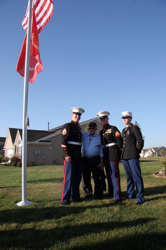 Marines took time out of the celebration to pose with Mr. Melvin Moore, a 90-year-old Marine Corps and World War II veteran. (Left to Rigt) Staff Sgt. William Genochio, a recruiter with RSS North Indianapolis, Melvin Moore, Sgt. Brian Frances,a recruiter with RSS North Indianapolis , and Pvt. Brianna Ayers, a young Marine recently returning from recruit training.