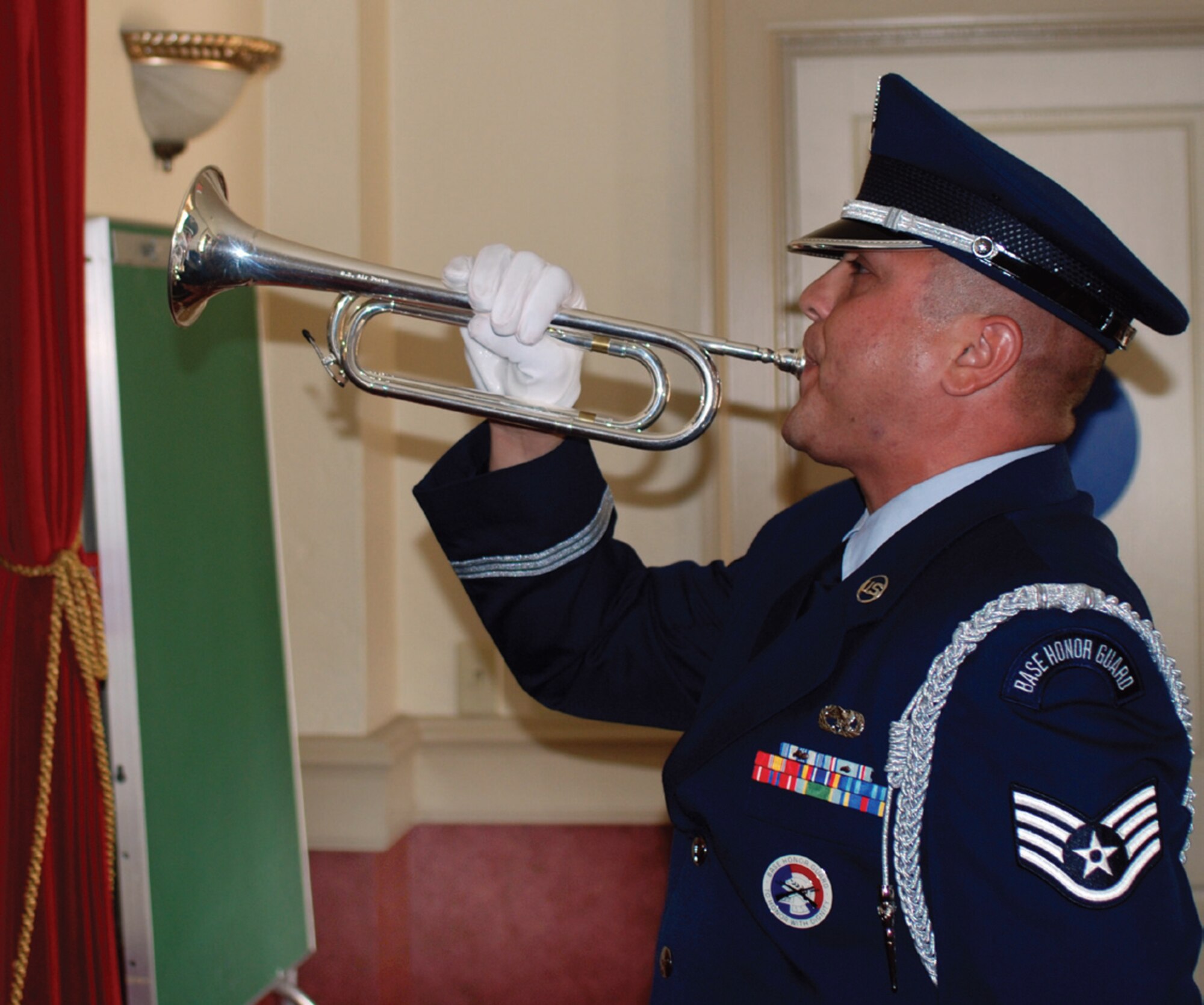 Staff Sgt. Mario Gomez, Blue Eagles Total Force Honor Guard, plays taps on his bugle. The 9/11 Remembrance Service was held in the Cultural Resource Center on Friday, Sept. 11. (U.S. Air Force photo by Megan Just)