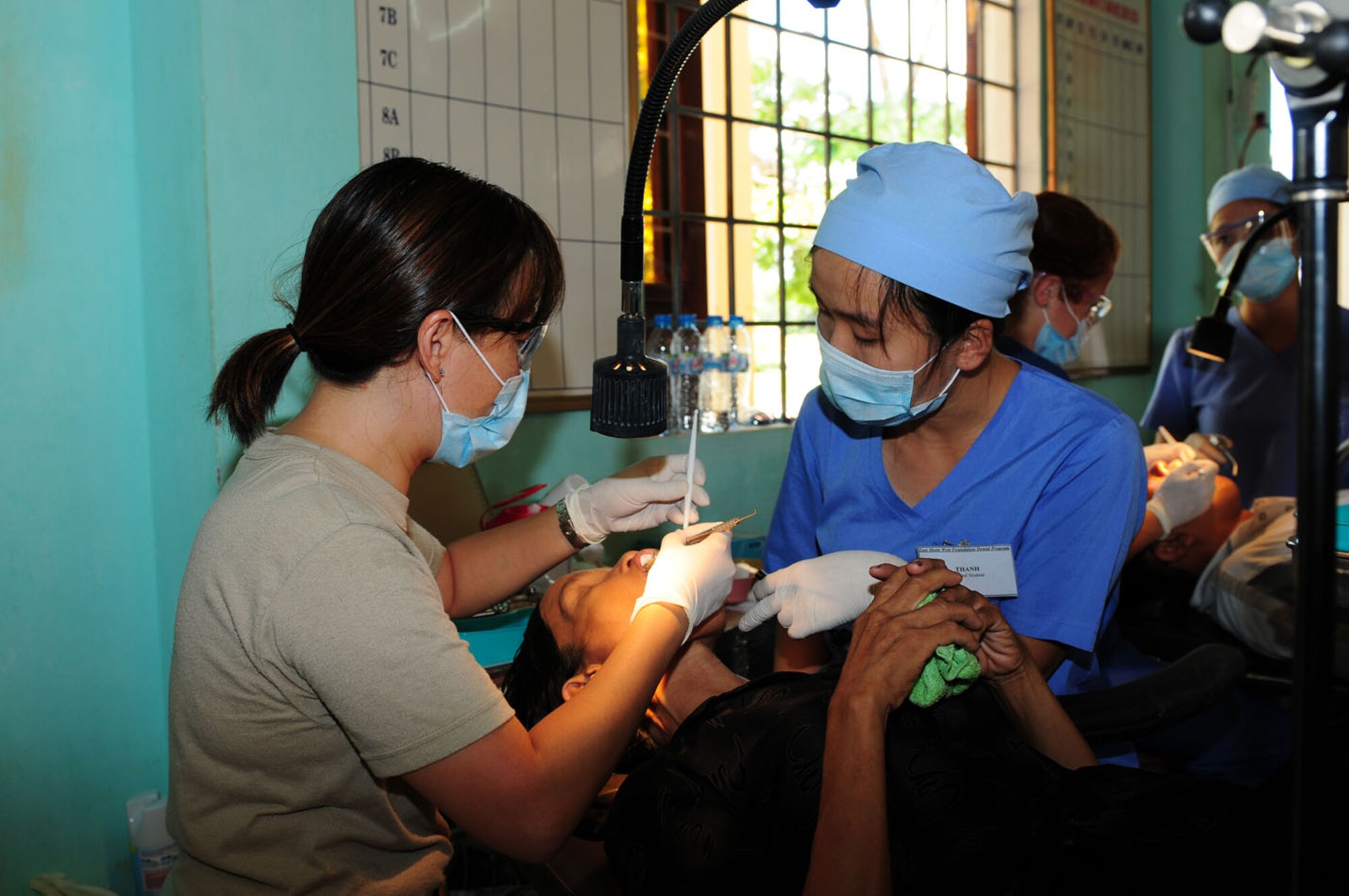 Maj. (Dr.) Diep Le (left), a dentist and Air Force Reservist from Travis Air Force Base, Calif., provides dental care to a Vietnamese patient Sept. 18 as part of Operation Pacific Angel 2009 in Quang Tri Province, Vietnam.  Dr. Le is part of a team of Air Force medical professionals and civil engineers in Vietnam providing humanitarian assistance in cooperation with local authorities to Quang Tri Province residents Sept. 15 to 24. Pacific Angel is a Pacific Air Forces operation led by 13th Air Force at Hickam Air Force Base, Hawaii. The joint and combined humanitarian assistance operation is conducted in the Pacific area of responsibility to support U.S. Pacific Command’s capacity-building efforts. (U.S. Air Force photo/Tech. Sgt. Kerry Jackson)