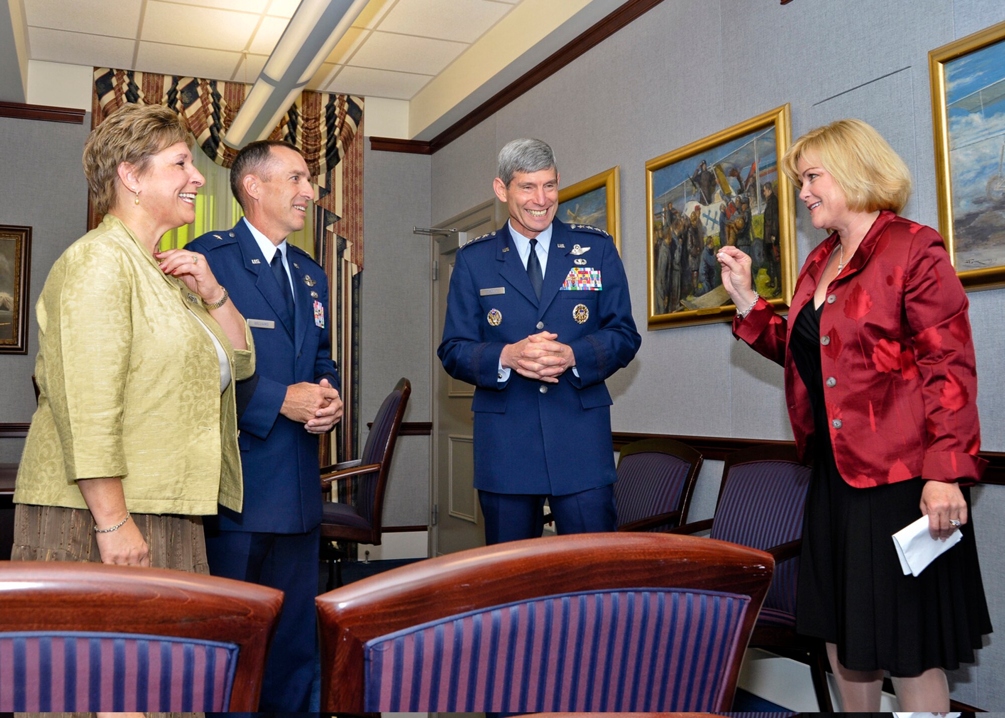 Sharon O'Malley Burg, daughter of the late Gen. Jerome and Diane O'Malley, makes a point during an informal conversation with Air Force Chief of Staff Gen. Norton Schwartz and Brig. Gen. Brett and Marianne Williams prior to the start of a ceremony at the Pentagon Sept. 11, 2009, honoring General and Mrs. Williams.  They are the recipients of the 2009 General and Mrs. Jerome O'Malley Award.  The award was established after the O'Malleys, who were known for their leadership and contributions to Air Force families and communities, were killed in a plane crash in 1985.  (U.S. Air Force photo/Michael Pausic)
