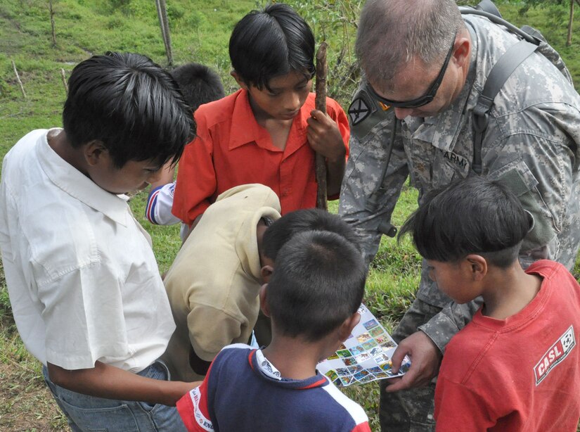 U.S. Army Maj. Andrew Dula hands out stickers to children living in a remote, mountainous area of Costa Rica Sept. 11, 2009. A team of members representing the Costa Rica Ministry of Health and Joint Task Force-Bravo provided medical care and education to nearly 400 patients in need during the two-day exercise. (U.S. Air Force photo/Tech. Sgt. Mike Hammond)