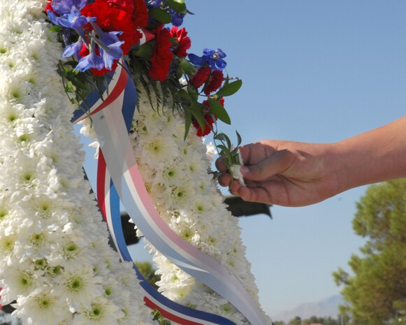 NELLIS AIR FORCE BASE, Nev.-- A cadet from the Rancho High School Air Force Junior Reserve Officers' Training Corps places a daisy on the memorial wreath in honor of Nevada Veterans during the Nellis 2009 Prisoners of War/Missing in Action Recognition Day ceremony at Freedom Park, here,  Sept. 18. (U.S Air Force photo by Staff Sgt. Taylor Worley)

