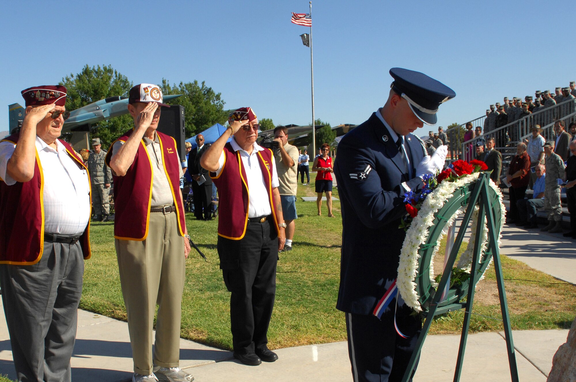 NELLIS AIR FORCE BASE Nev.,-- George Kielak, Carroll Knutson and Eugene Ramos, members of the the 7-11 Chapter of American Ex-Prisoners Of War, salute the memorial wreath in honor of Nevada Veterans who were prisoners of war and for those who are missing in action, during a POW/MIA ceremony at Freedom Park, here, Sept. 18.  (U.S. Air Force photo by Staff Sgt. Taylor Worley)
