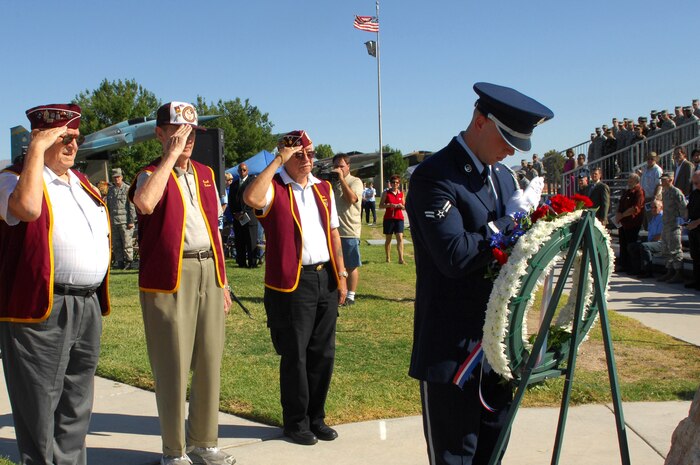 NELLIS AIR FORCE BASE Nev.,-- George Kielak, Carroll Knutson and Eugene Ramos, members of the the 7-11 Chapter of American Ex-Prisoners Of War, salute the memorial wreath in honor of Nevada Veterans who were prisoners of war and for those who are missing in action, during a POW/MIA ceremony at Freedom Park, here, Sept. 18.  (U.S. Air Force photo by Staff Sgt. Taylor Worley)
