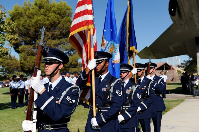 NELLIS AIR FORCE BASE, Nev.-- Nellis Air Force Base Honor Guardsmen present the colors at the 2009 National Prisoners of War/Missing in Action Recognition Day, here, Sept. 18. During the ceremony, Nevada veterans and those missing in action were honored. (U.S. Air Force photo by Airman 1st Class Brett Clashman)
