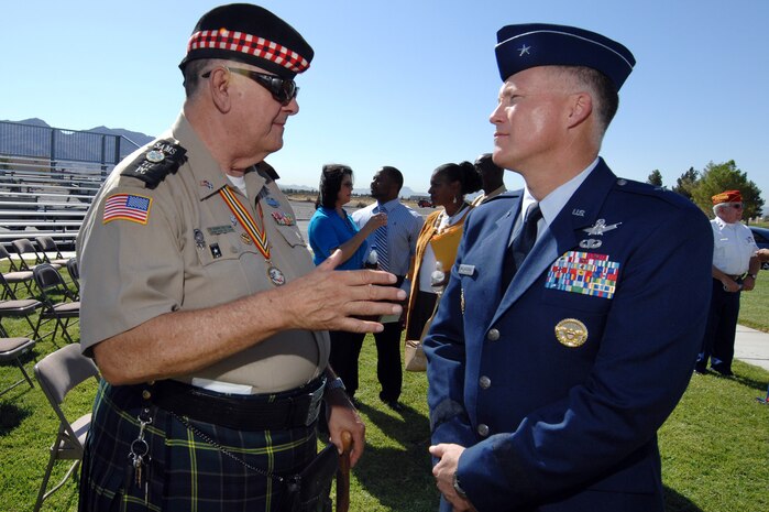 NELLIS AIR FORCE BASE, Nev.-- Ed Gilmore, Scottish American Military Society Post 777 commander, speaks with Brig. Gen. Kevin McLaughlin, United States Air Force Warfare Center vice commander, at the Nellis 2009 Prisoners of War/Missing in Action Recognition Day ceremony, here, Sept. 18. The ceremony is held annually for surviving veterans and those that never returned home from combat. (U.S. Air Force photo by Lawrence Crespo)