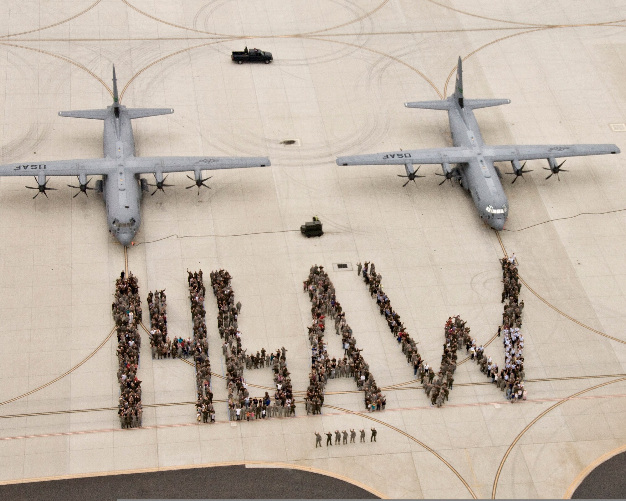 Airmen assigned to the 146th Airlift Wing stand in a formation on the flightline of Channel Islands Air National Guard Station in Port Hueneme, Calif., on Sept. 13, 2009. During the formation, the Airmen spelled out their unit to celebrate receiving the Air National Guard's Hometown Heroes Award. The unit received the award for being deployed overseas in support of the war on terrorism. (U.S. Air Force Photo/Tech. Sgt. Alex Koenig) 