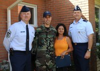 Col. Don Shaffer, right, and Chief Master Sgt. Mike Ivey, left, join Tech. Sgt. J.S. Wilcox and his wife, Angelina, for the presentation of the "Yard of the Month" award in Charleston AFB family housing Sept. 14. Sergeant Wilcox's home was chosen above several others previously selected as "Yard of the Week" and was the final award presented for 2009. Colonel Shaffer is the 437th Airlift Wing vice commander, Chief Ivey is the 437 AW command chief, and Sergeant Wilcox is a combat videographer with the 1st Combat Camera Squadron. (U.S. Air Force photo/Senior Airman Katie Geiratz)