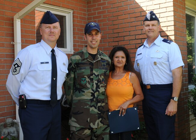Col. Don Shaffer, right, and Chief Master Sgt. Mike Ivey, left, join Tech. Sgt. J.S. Wilcox and his wife, Angelina, for the presentation of the "Yard of the Month" award in Charleston AFB family housing Sept. 14. Sergeant Wilcox's home was chosen above several others previously selected as "Yard of the Week" and was the final award presented for 2009. Colonel Shaffer is the 437th Airlift Wing vice commander, Chief Ivey is the 437 AW command chief, and Sergeant Wilcox is a combat videographer with the 1st Combat Camera Squadron. (U.S. Air Force photo/Senior Airman Katie Geiratz)