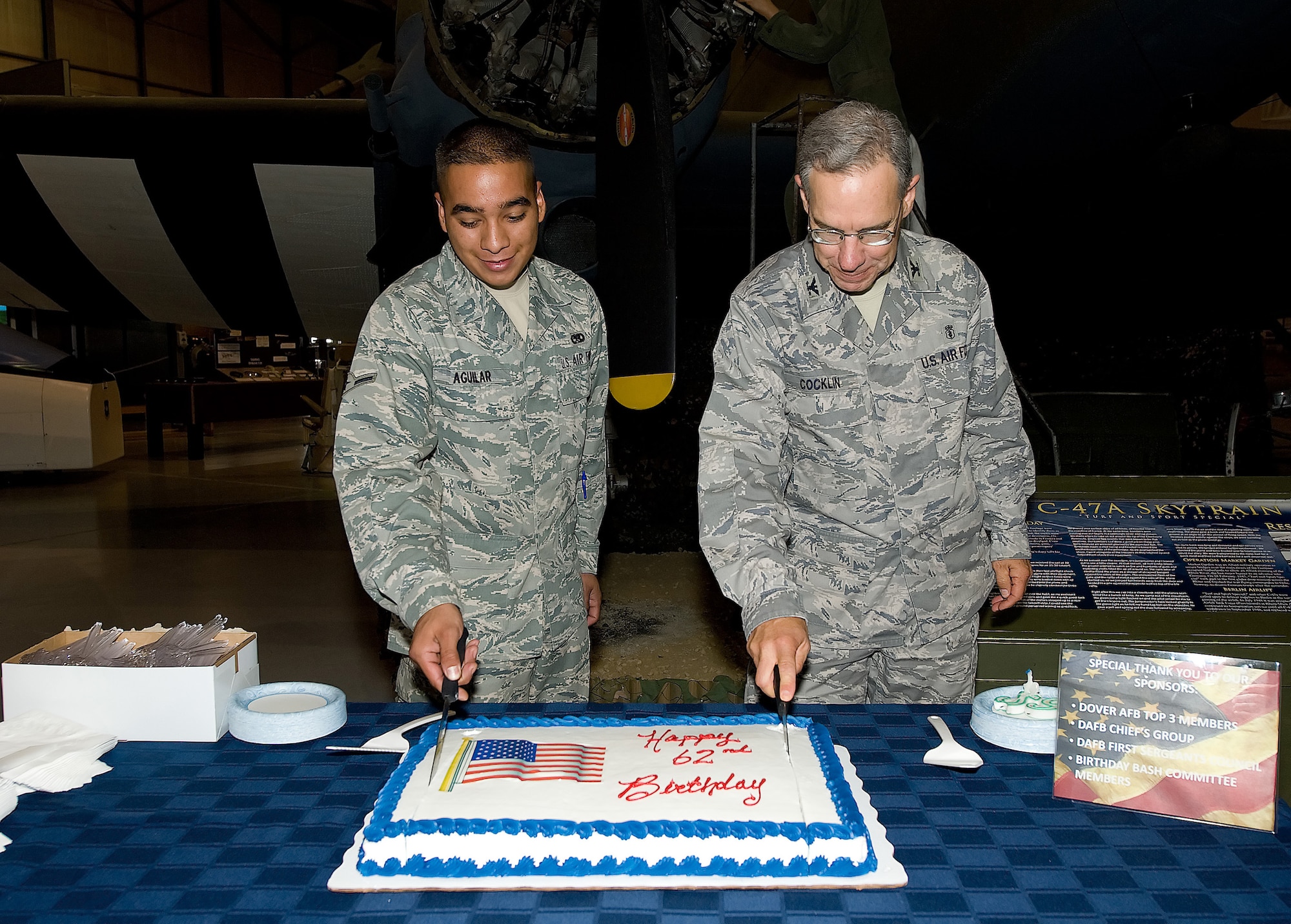 (From left) Airman Mariano Aguilar, 436th Maintenance Squadron, and Col. James Cocklin, 436th Dental Squadron commander, cut the cake at the Air Force Birthday Bash at the Air Mobility Command Museum Sept. 18. Airman Aguilar and Colonel Cocklin are the youngest and oldest Airmen, respectively, currently on station at Dover Air Force Base. (U.S. Air Force photo/Jason Minto)