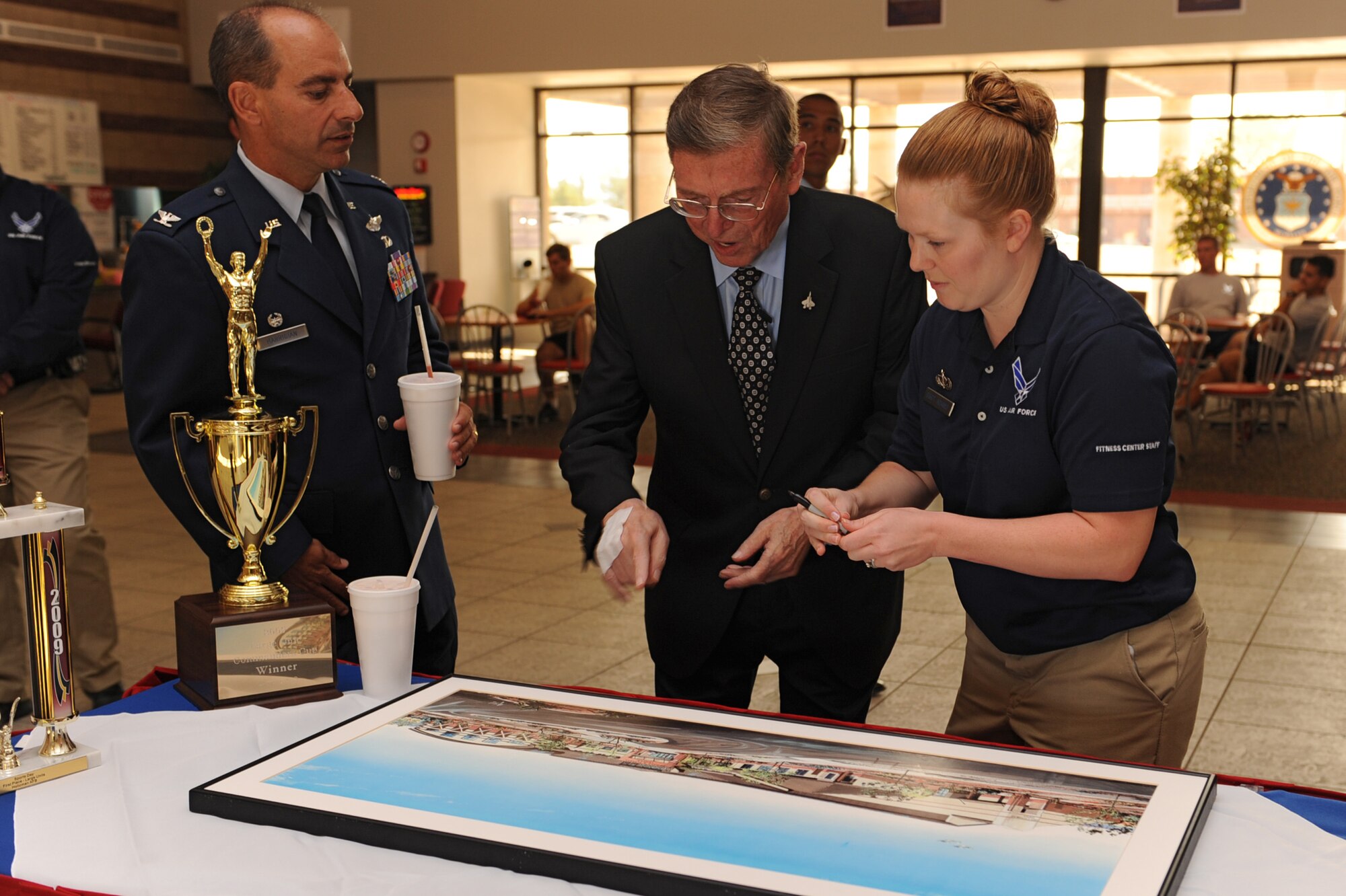 HOLLOMAN AIR FORCE BASE, N.M. -- Senator Pete Domenici retired U.S. senator, signs a painting of the Domenici Fitness and Sports Center here Sept. 18 at the official renaming of the Holloman Fitness and Sports Center. Domenici served as the chairman of the U.S. Senate committees on Appropriations, Budget and Energy and Natural Resources, while serving as a member of the Indian Affairs and Homeland Security and Governmental Affairs committees. (U.S. Air Force photo by Senior Airman Rachel Kocin)