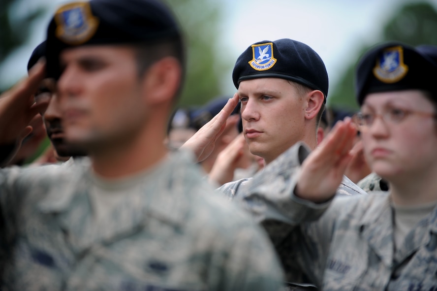 MOODY AIR FORCE BASE, Ga. -- Team Moody Airmen salute during the playing of the National Anthem at the Prisoner of War/Missing in Action Remembrance Day ceremony held here Sept. 18. The ceremony was held to commemorate those individuals who were held as POWs and to remember those who are still MIA. (U.S. Air Force photo by Senior Airman Gina Chiaverotti-Paige)