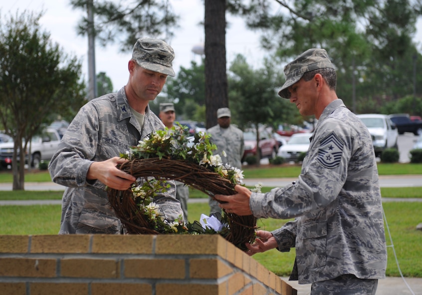 MOODY AIR FORCE BASE, Ga. -- Col. Gary Henderson, 23rd Wing commander, and Command Chief Master Sgt. Richard Parsons, 23rd wing command chief, pay their respects to the men and women of the armed forces who have been prisoners of war or missing in action during the POW/MIA Remembrance Day ceremony here Sept. 18. (U.S. Air Force photo by Senior Airman Gina Chiaverotti-Paige)