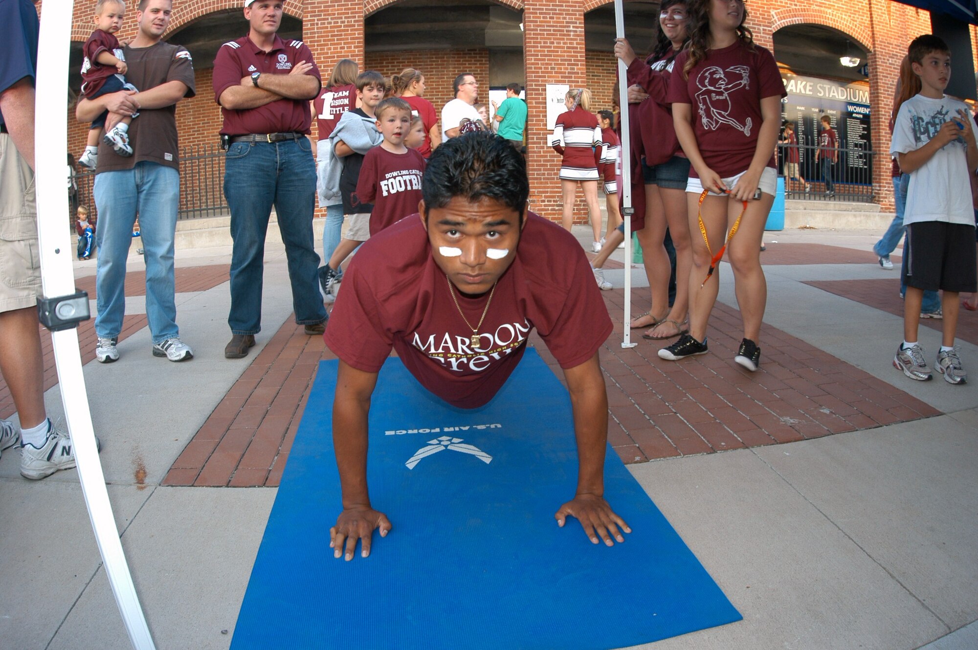 Jason Perez, a Dowling High School senior, participates in the Power Push-up Challenge prior to the Great American Rivalry Series game between Dowling Catholic and Valley Sept. 4 in Des Moines, Iowa. The Series is sponsored by the U.S. Air Force. (U.S. Air Force photo/Tech. Sgt. David McCarrison)